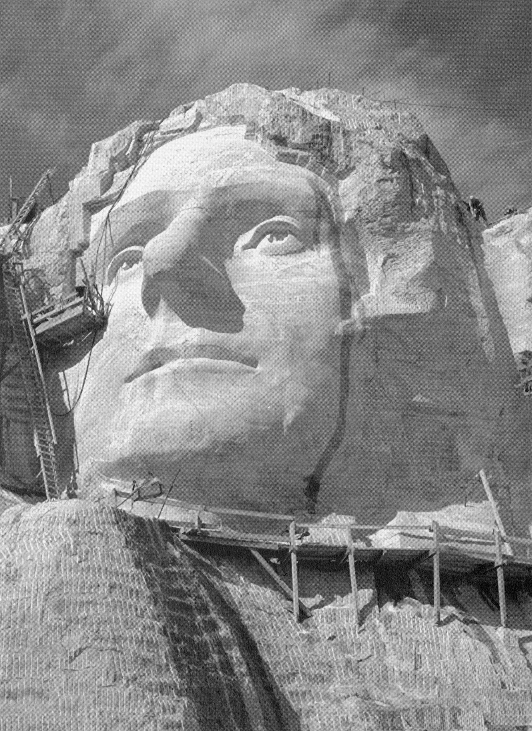 A closer view of the face of Thomas Jefferson under construction, with drill marks below it, c. 1930s.