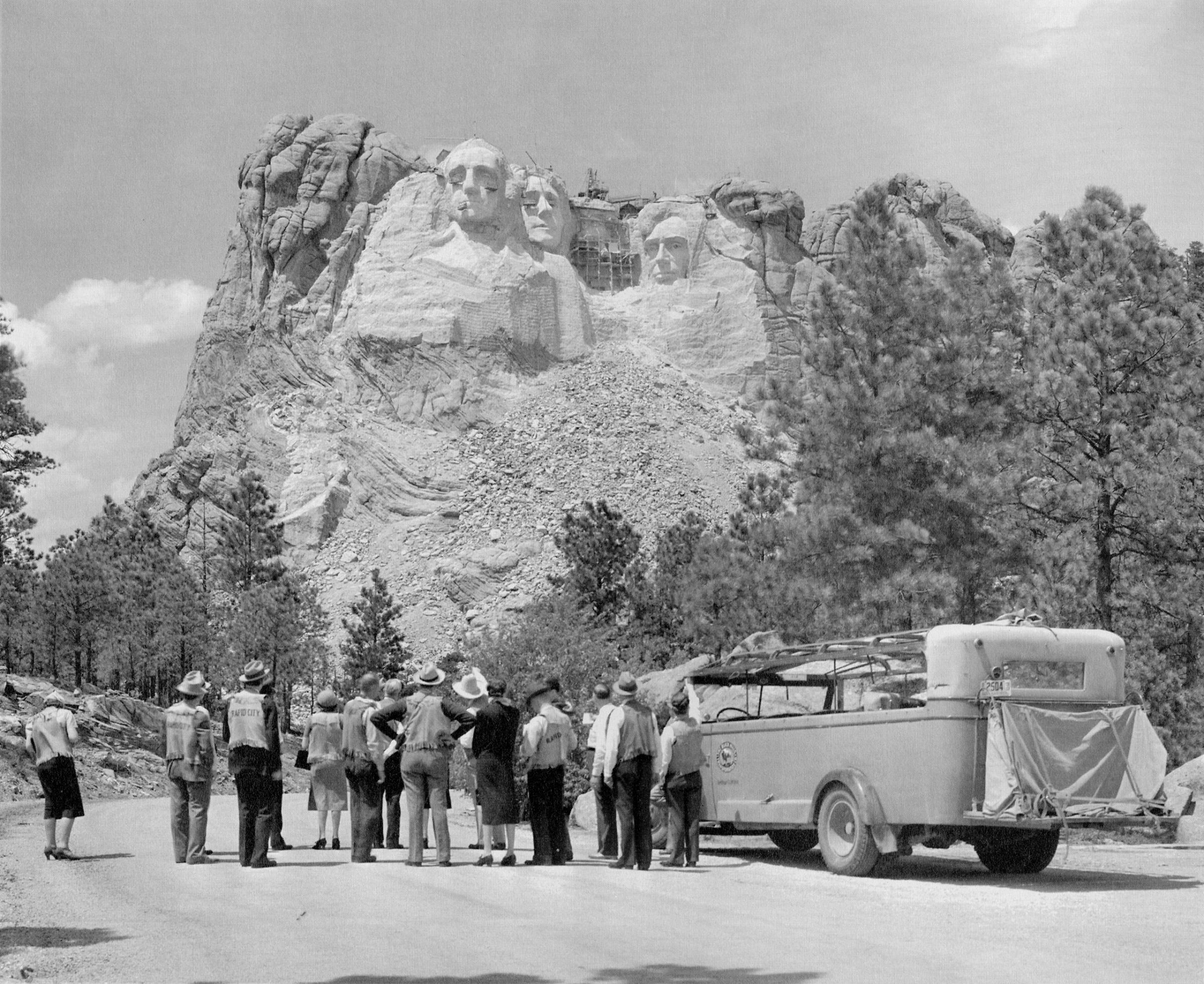 Tourists stopped to view Mount Rushmore while it was still under construction, c. 1930s.