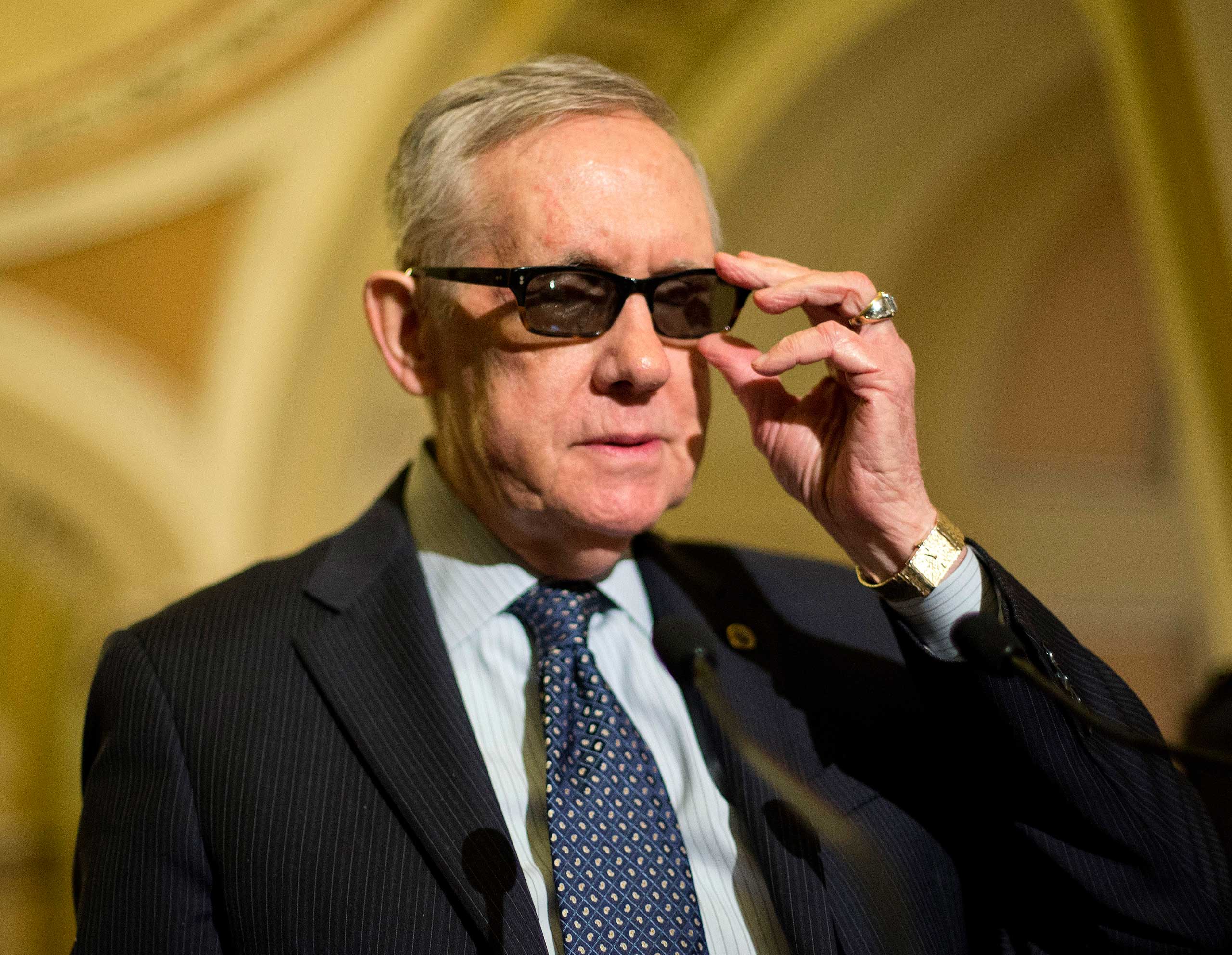 Senate Minority Leader Harry Reid of Nev. adjusts his glasses as he speaks to reporters on Capitol Hill in Washington, March 24, 2015. (Pablo Martinez Monsivais—AP)
