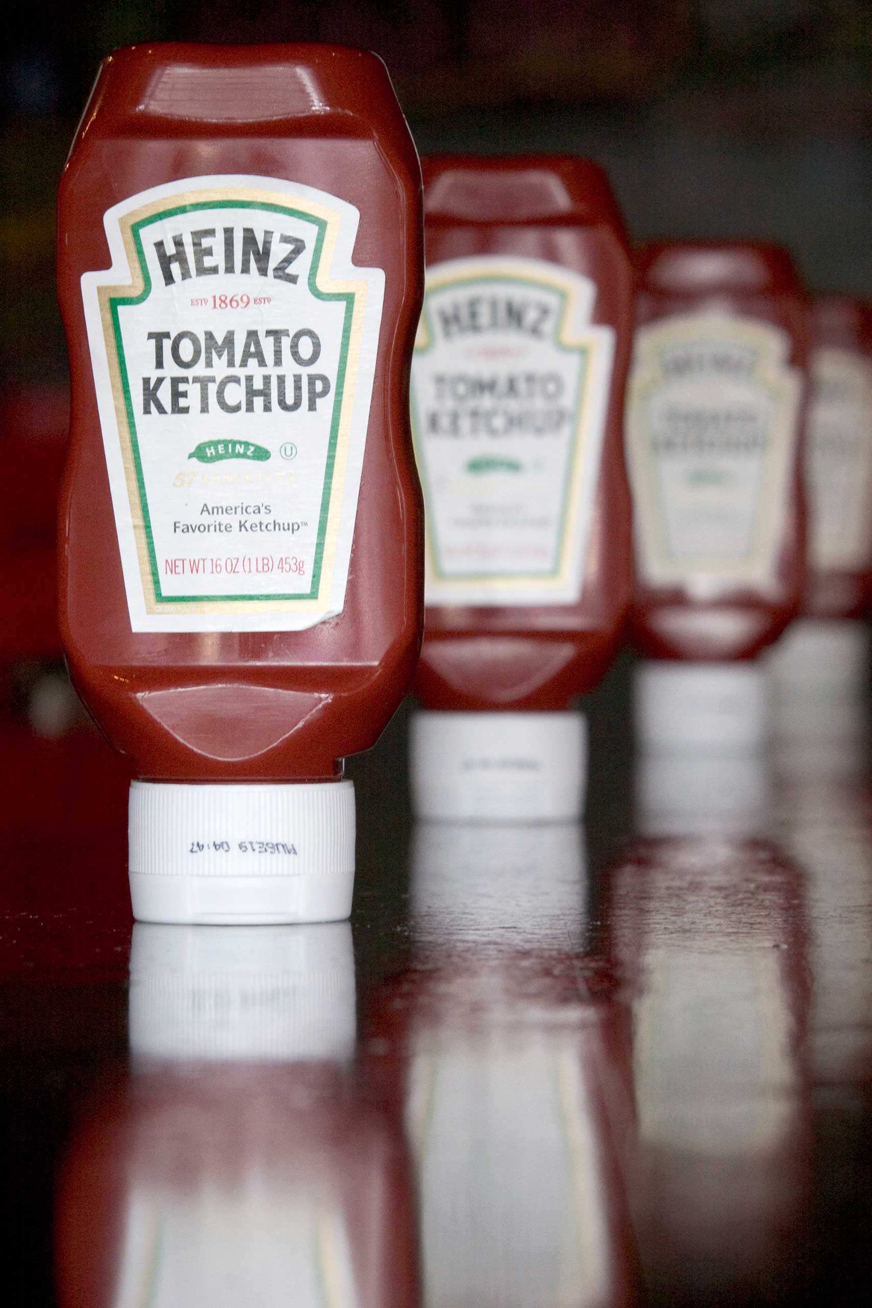 Bottles of Heinz ketchup are arranged on the bar at Cambridge Common restaurant in Cambridge, Massachusetts Wednesday, July 19, 2006. H.J. Heinz Co., fighting billionaire investor Nelson Peltz's attempt to restructure the company, forecast first-quarter earnings would exceed analysts' estimates, driven by sales in the U.S. and Canada. Photographer: JB Reed/Bloomberg News