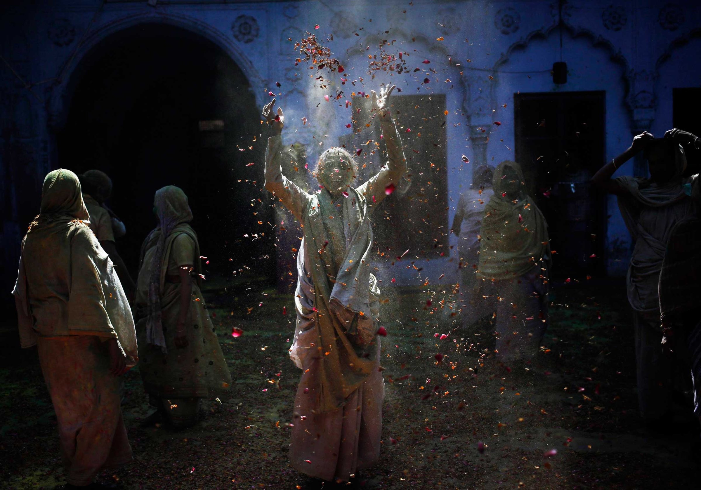 A widow throws flower petals as she, along with others, take part in the Holi celebrations organised by a non-governmental organisation Sulabh International at a widows' ashram at Vrindavan in the northern Indian state of Uttar Pradesh, March 4, 2015.