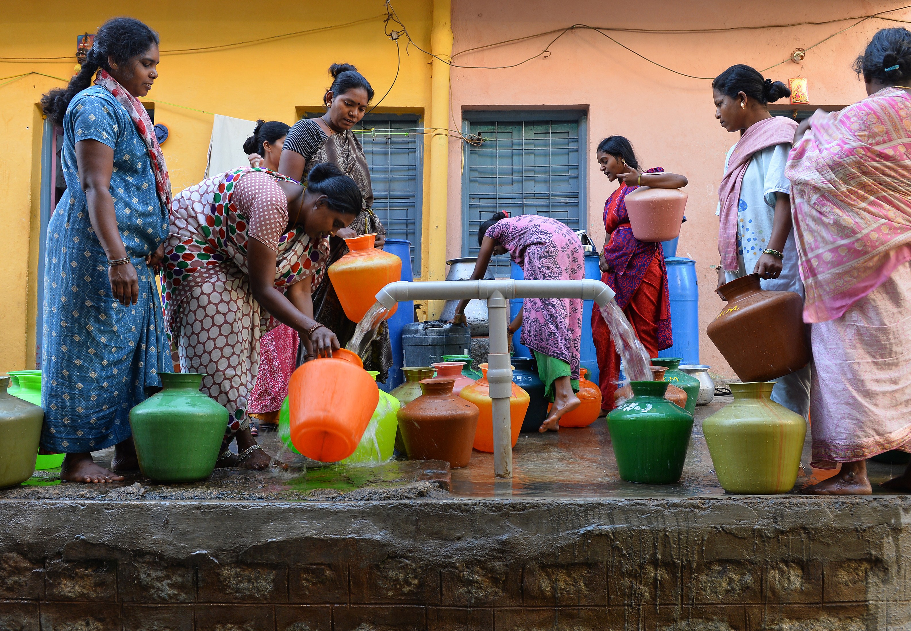 Residents in Bangalore wait to collect drinking water in plastic pots for their households on March 18, 2015. (Manjunath Kiran&mdash;AFP/Getty Images)