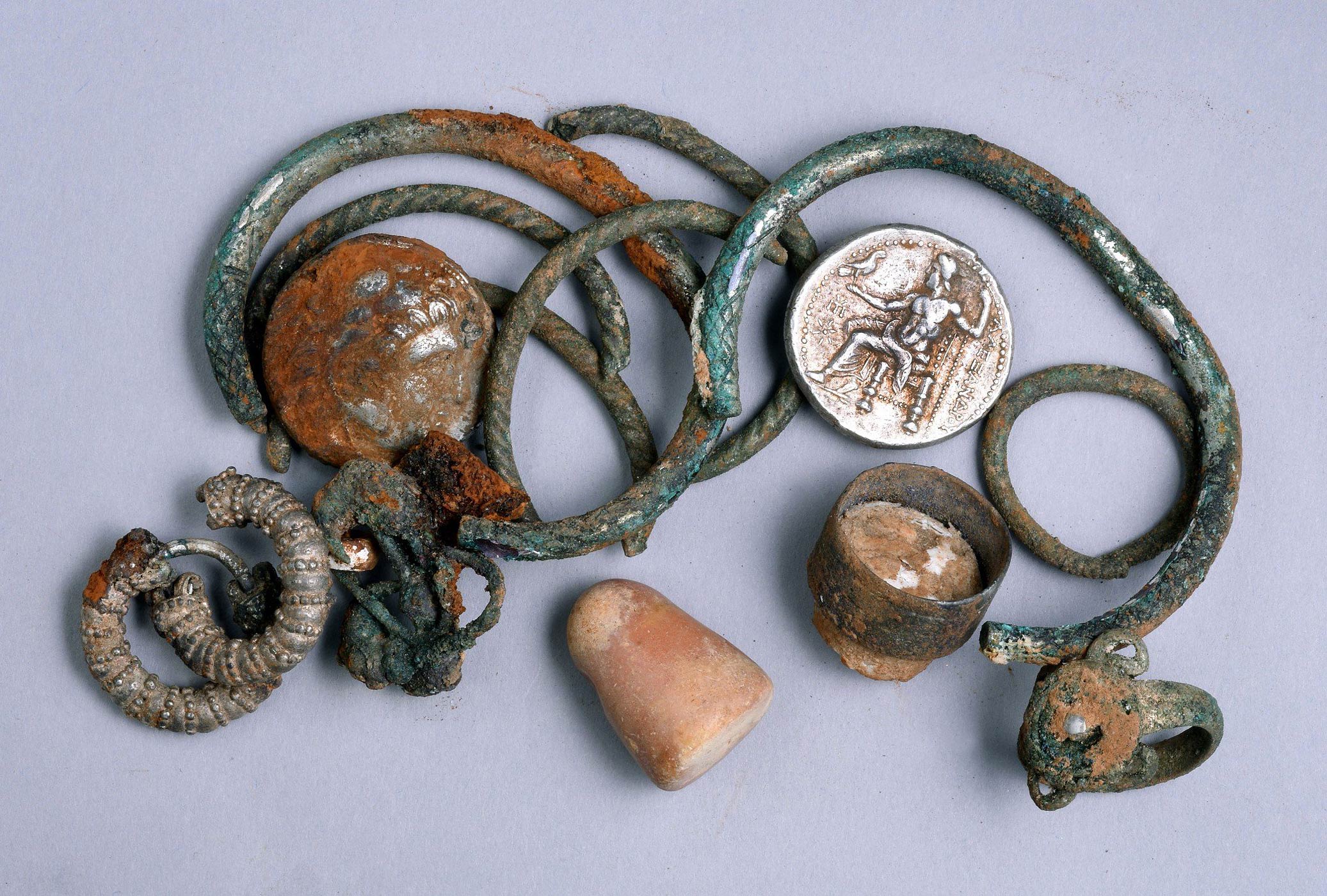 Ancient coins and other objects that were found by chance in a cave in northern Israel. (Clara Amit—Israel Antiquities Authority/Xinhua/Sipa USA)