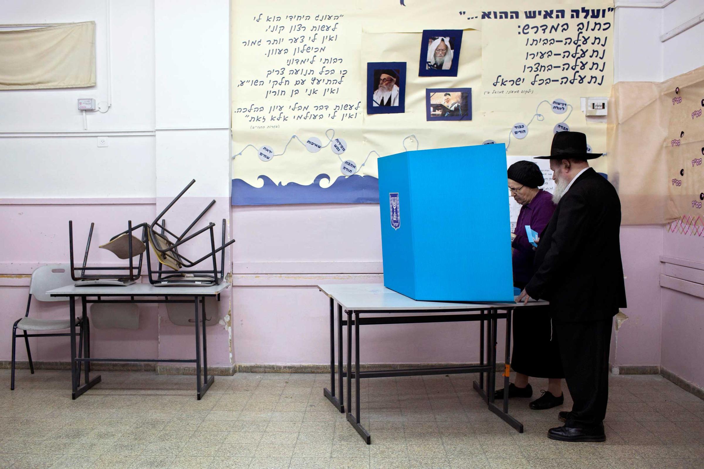 An ultra-Orthodox Jewish couple prepare to vote in Bnei Brak, March 17, 2015.