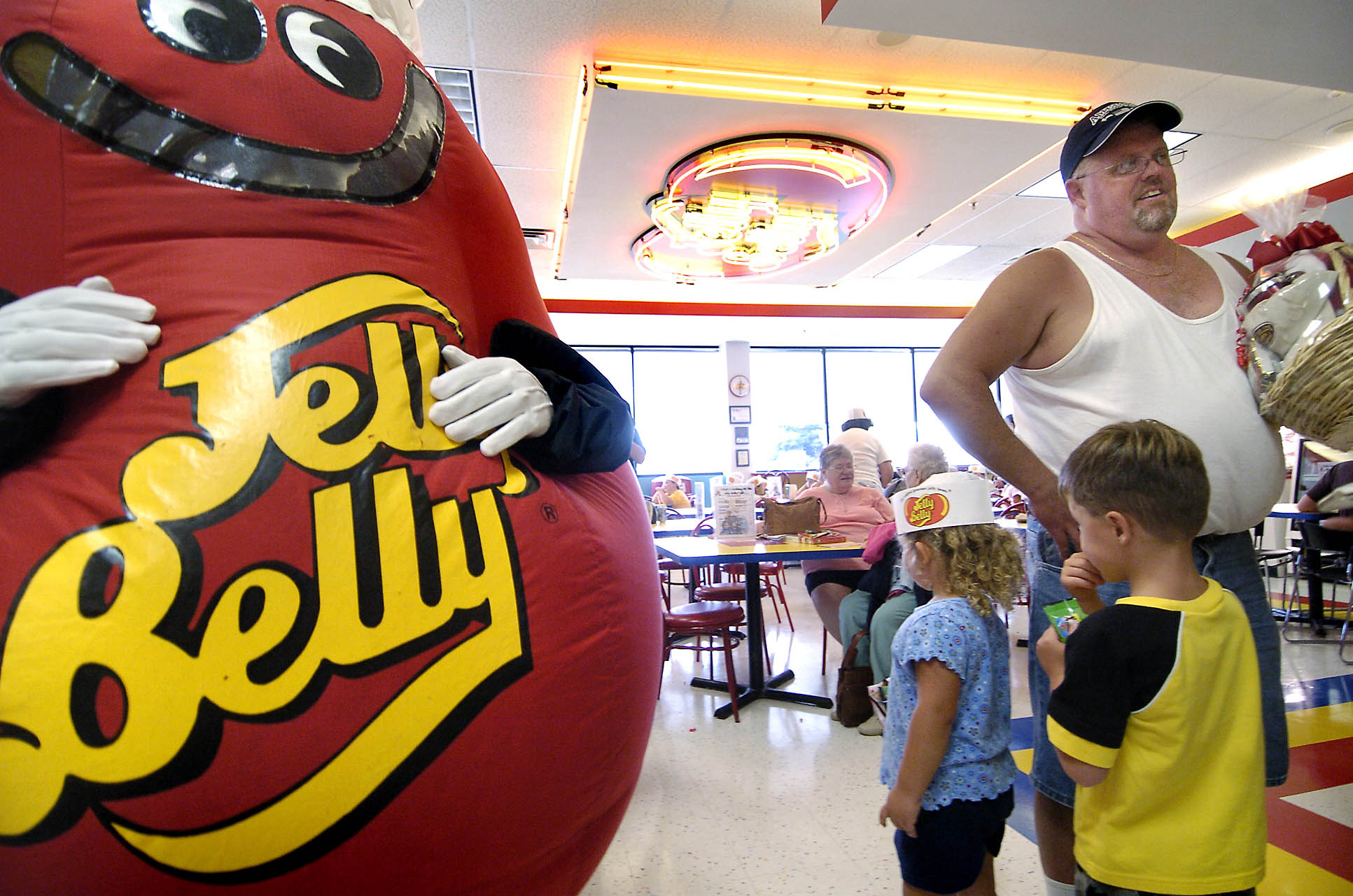 Michael Lively of Hammond, Ind., stands near the Mr. Jelly Belly mascot at the Jelly Belly Center in Pleasant Prairie, Wis on July 26, 2006.