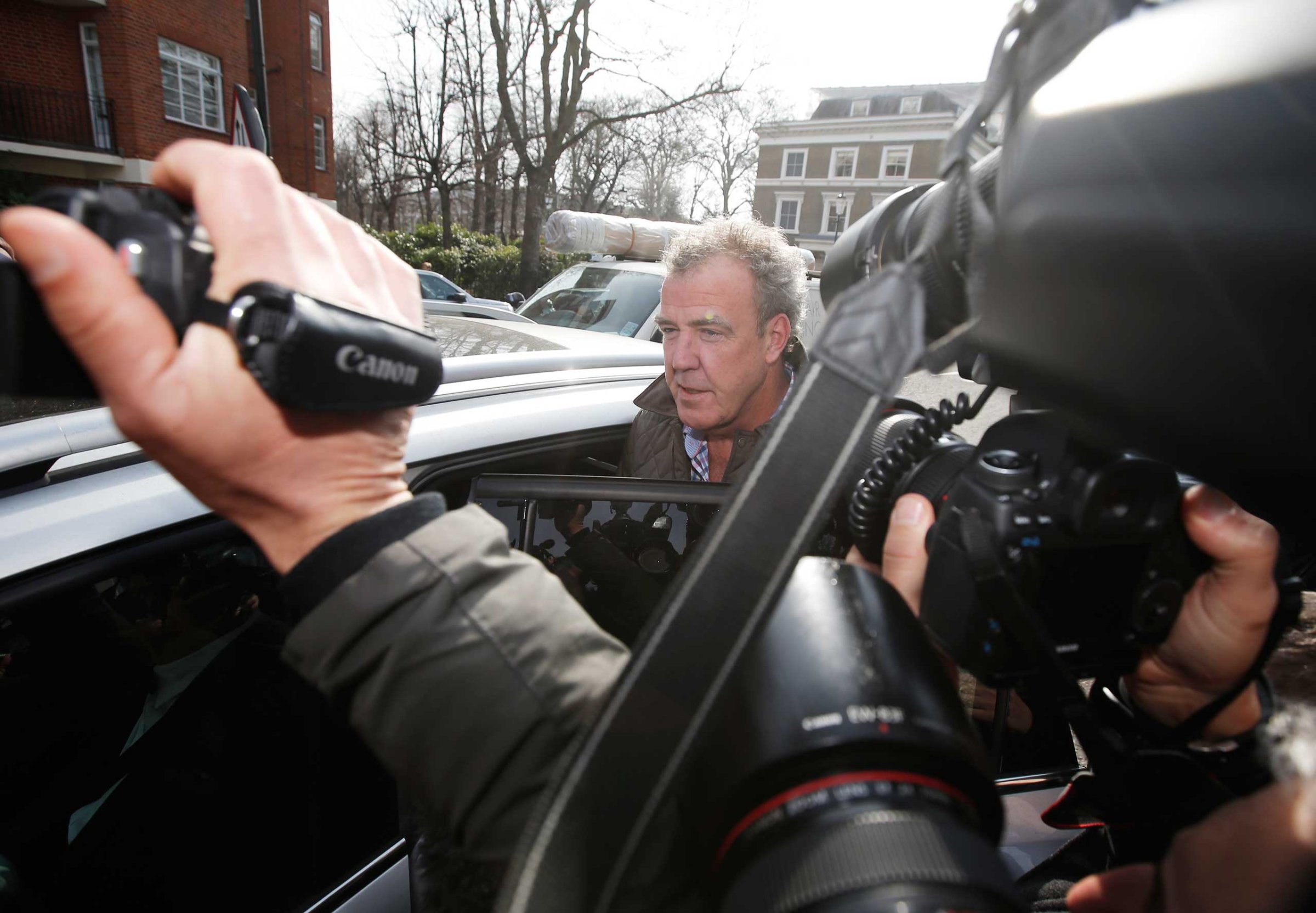 Television presenter Jeremy Clarkson is mobbed by journalists as he leaves an address in London, March 11, 2015.