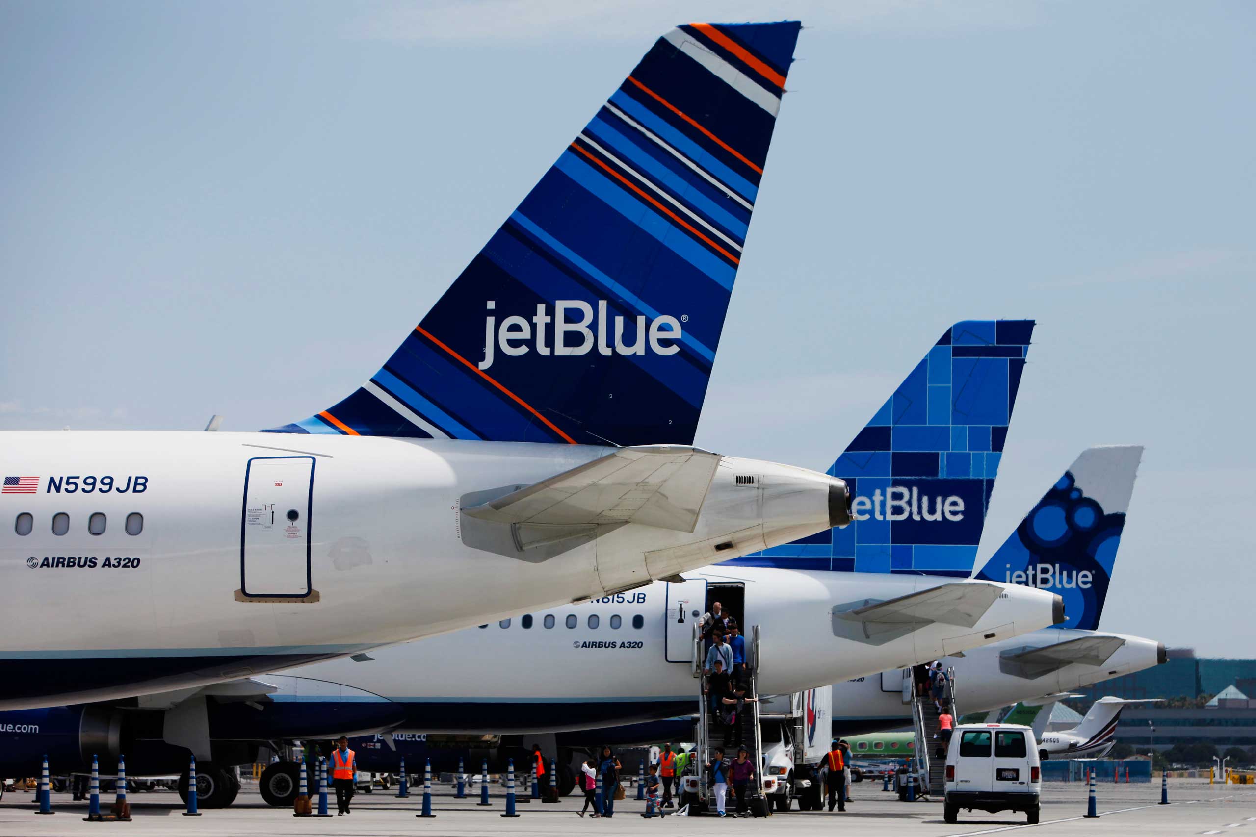 Passengers exit a JetBlue Airways Corp. plane at Long Beach Airport (LGB) in Long Beach, California, U.S., on Monday, July 22, 2013. (Bloomberg&amp;Bloomberg — Getty Images)