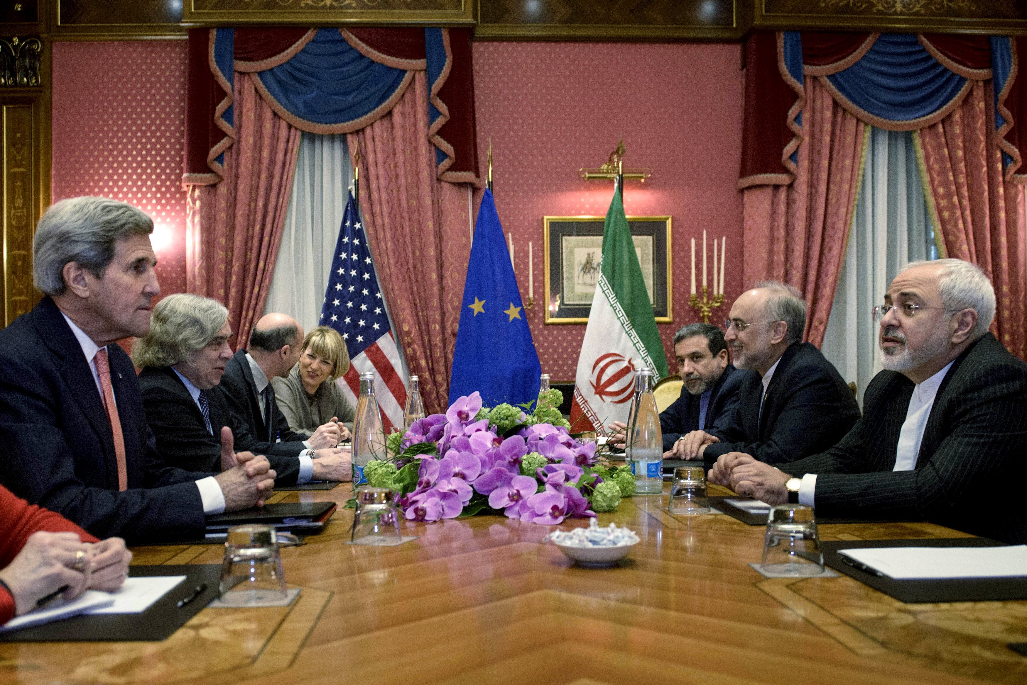 Secretary of State John Kerry, Iranian Foreign Minister Javad Zarif and others wait for a meeting at the Beau Rivage Palace Hotel on March 27, 2015 in Lausanne, Switzerland. (Brendan Smialowski—Reuters)