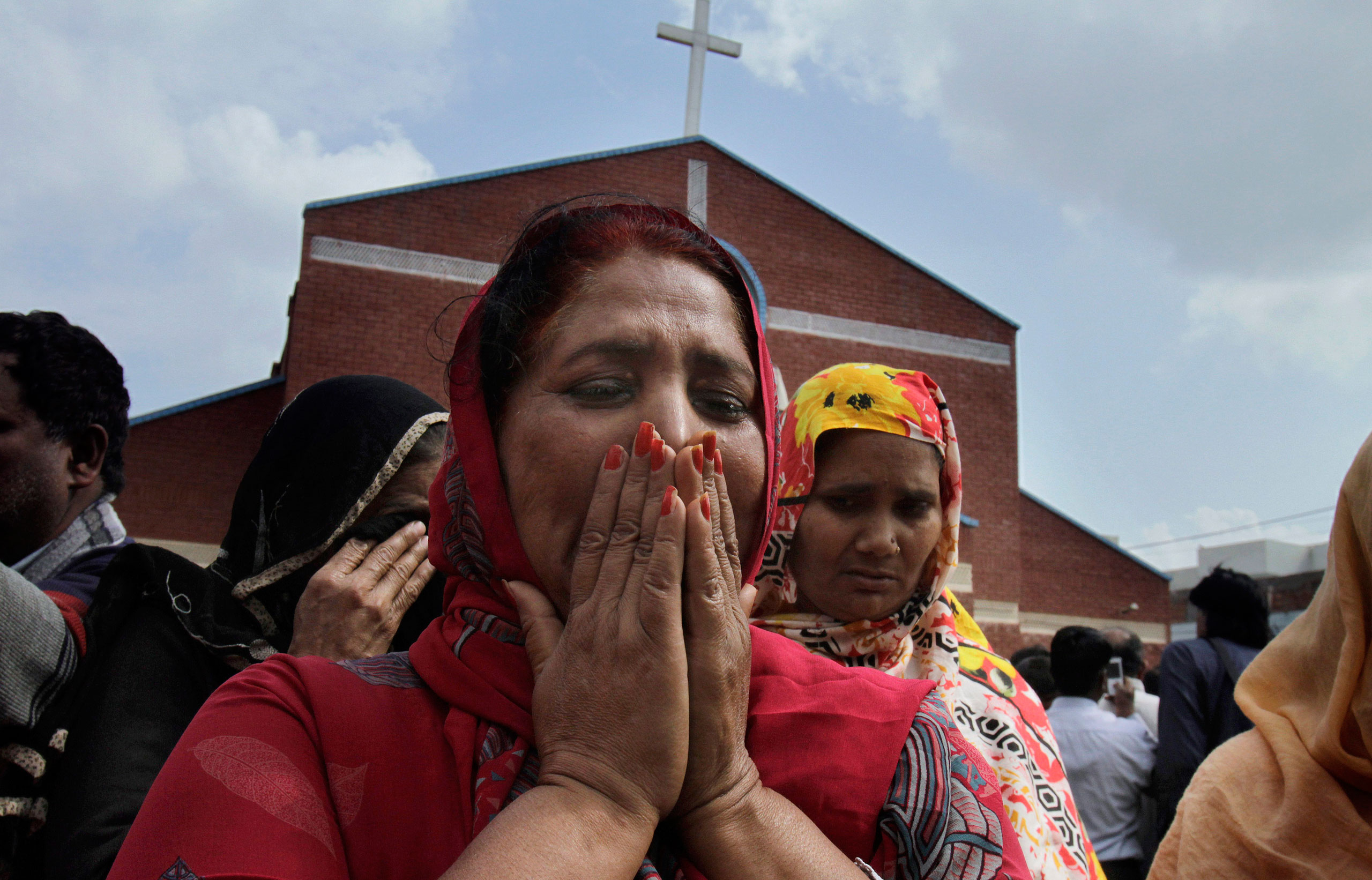 Pakistani Christian women mourn as they gather at a church damaged from a suicide bombing attack in Lahore, Pakistan, March 15, 2015. (K.M. Chaudary—AP)