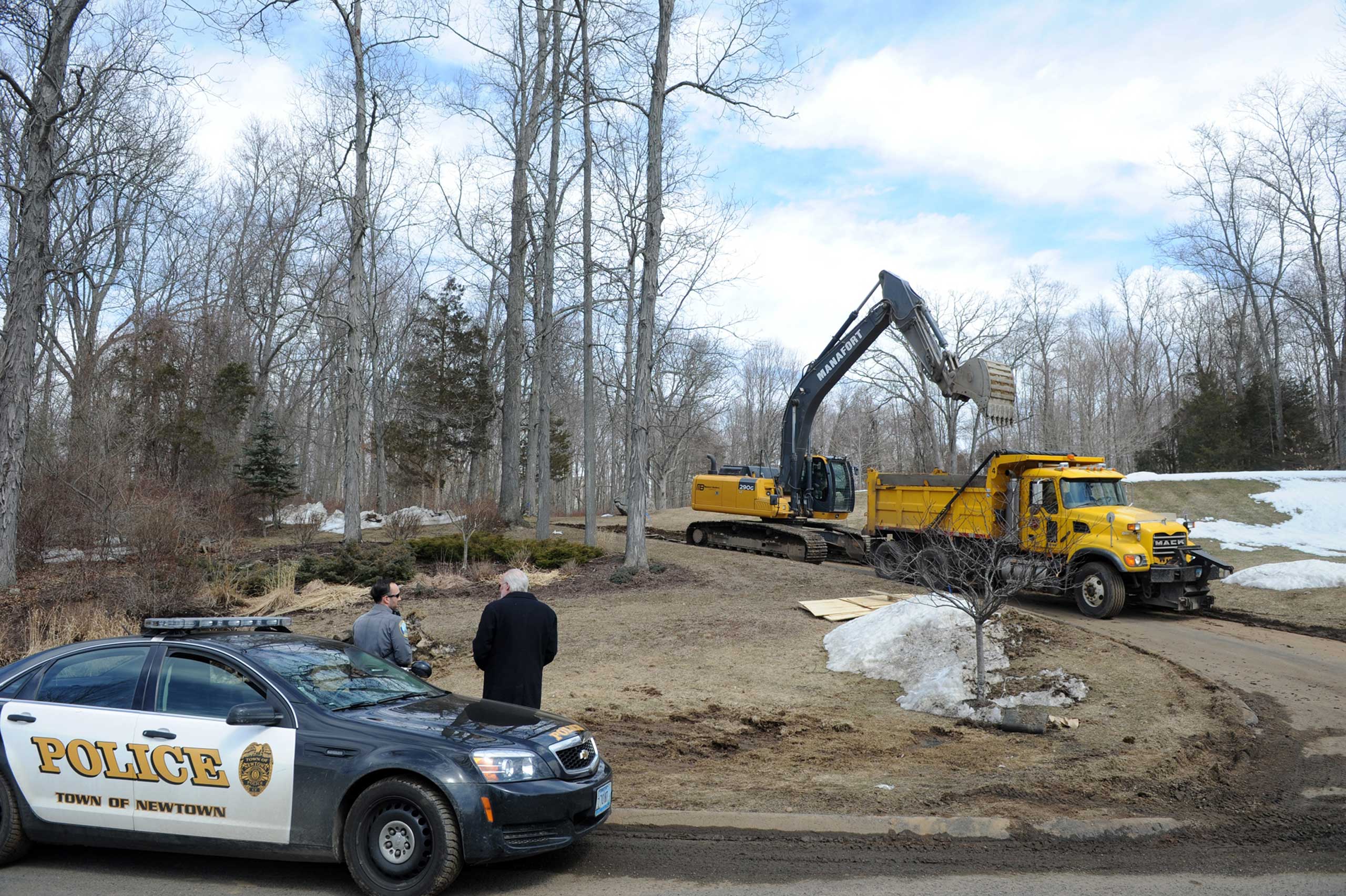 A crew finishes up the demolition, March 24, 2015, of the home of Nancy Lanza, where she had lived with her son Adam Lanza in Newtown, Conn. (Autumn Driscoll—AP)