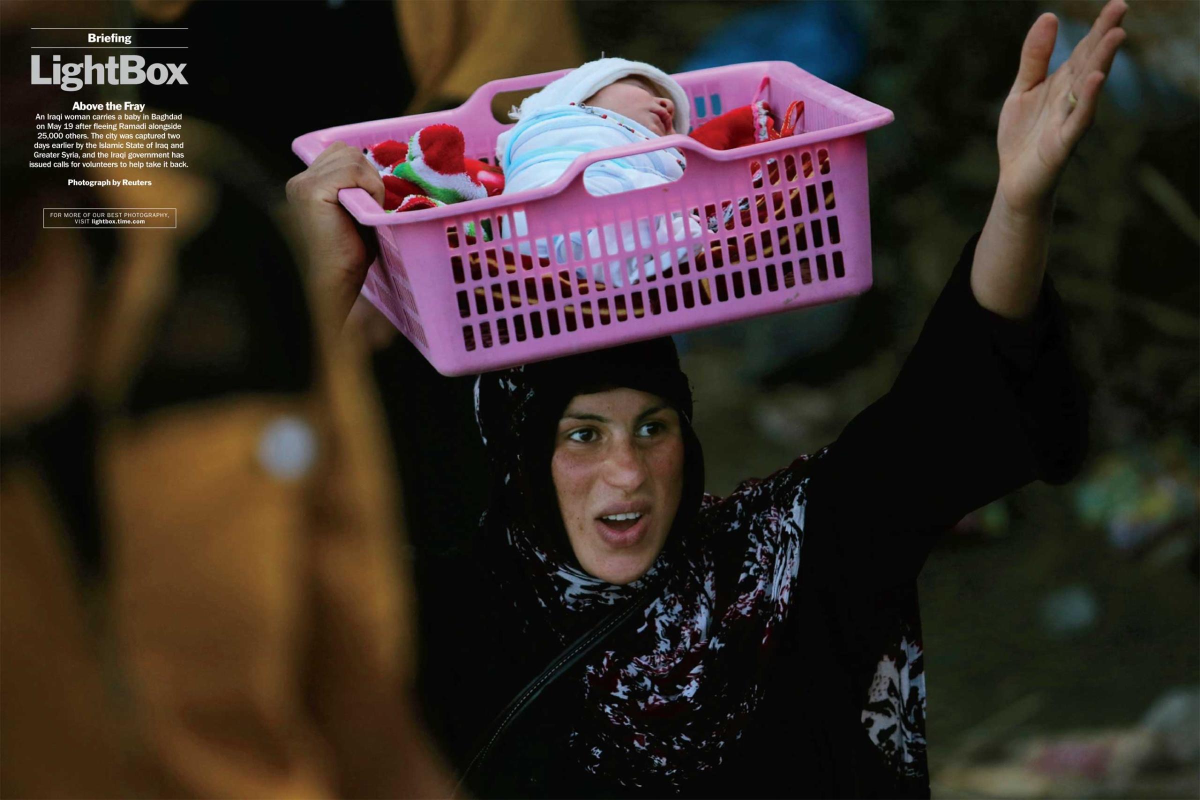 Photograph by ReutersAn Iraqi woman carries a baby in Baghdad on May 19 after fleeing Ramadi alongside 25,000 others. The city was captured two days earlier by the Islamic State of Iraq and Greater Syria, and the Iraqi government has issued calls for volunteers to help take it back. (TIME issue June 1, 2015)