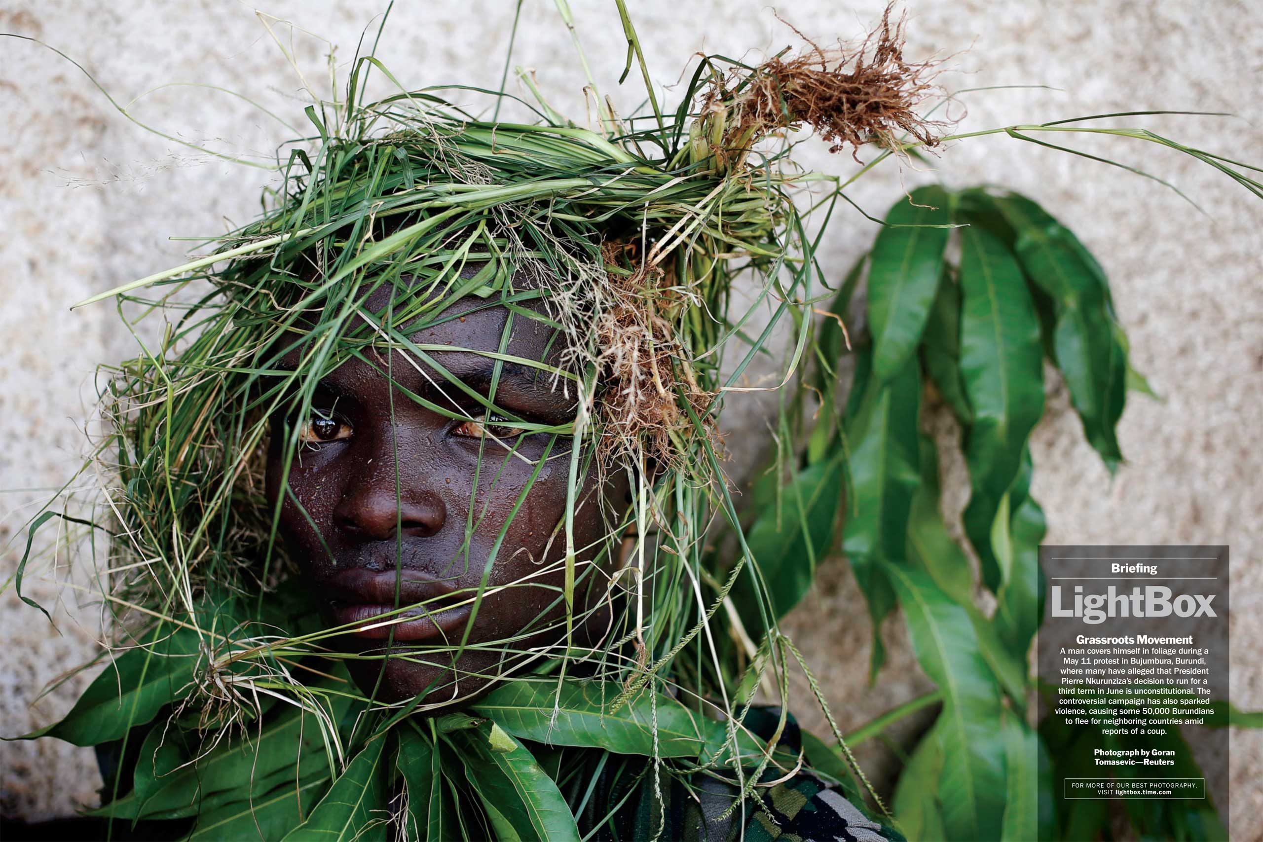 Photograph by Goran Tomasevic—ReutersA man covers himself in foliage during a May 11 protest in Bujumbura, Burundi, where many have alleged that President Pierre Nkurunziza's decision to run for a third term in June is unconstitutional. The controversial campaign has also sparked violence, causing some 50,000 Burundians to flee for neighboring countries amid reports of a coup. (TIME issue May 25, 2015)