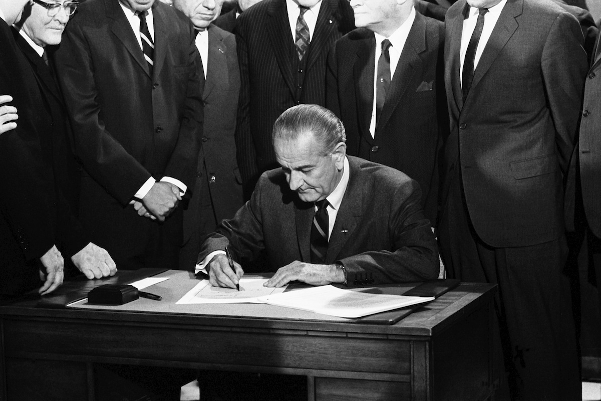 President Lyndon Johnson signs the Civil Rights bill  on April 11, 1968 (Warren Leffler / Getty Images)