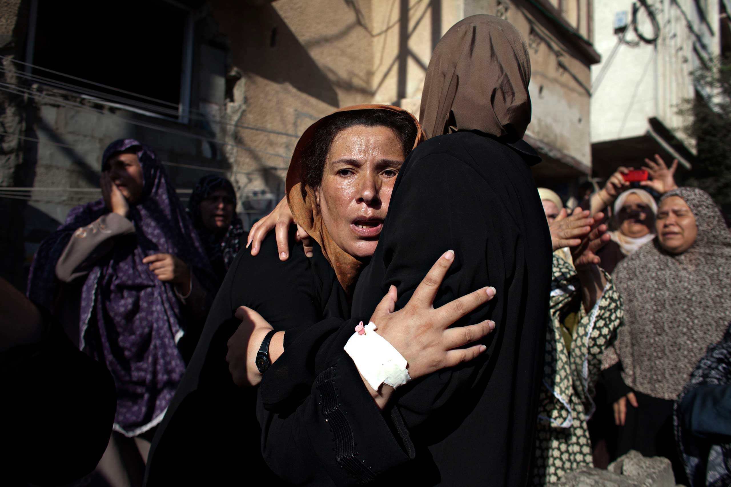 Women mourn during the funeral of boys who were killed by an Israeli naval bombardment in the port of Gaza, July 16, 2014.