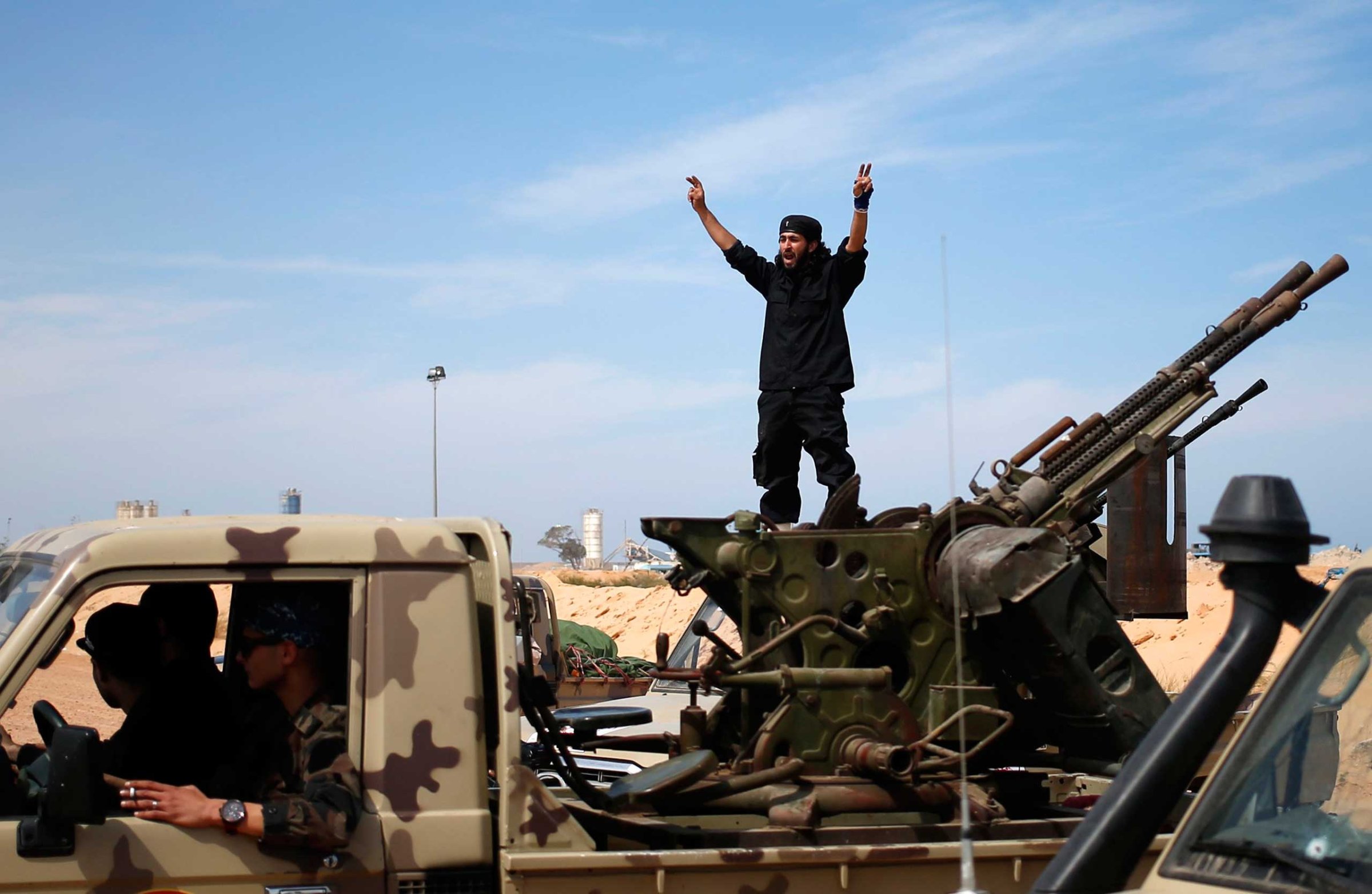 A fighter from Misrata shouts to his comrades as they move to fight ISIS militants near Sirte March 15, 2015.
