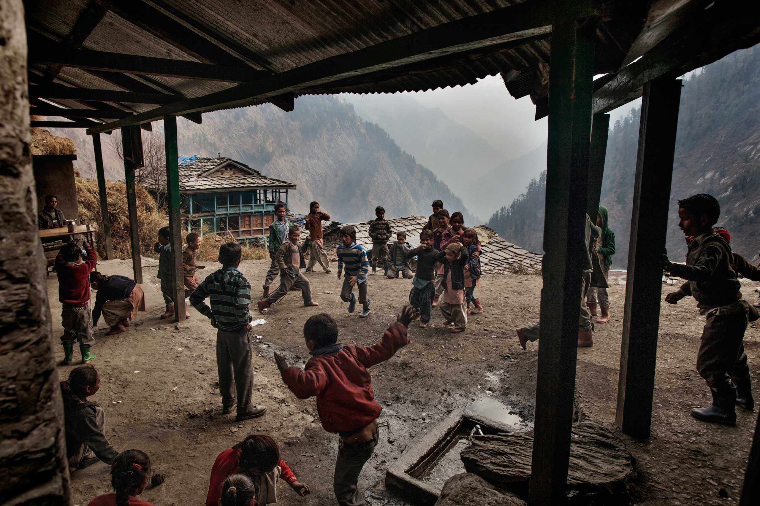 Children play in the village schoolyard in Dec. 2014.