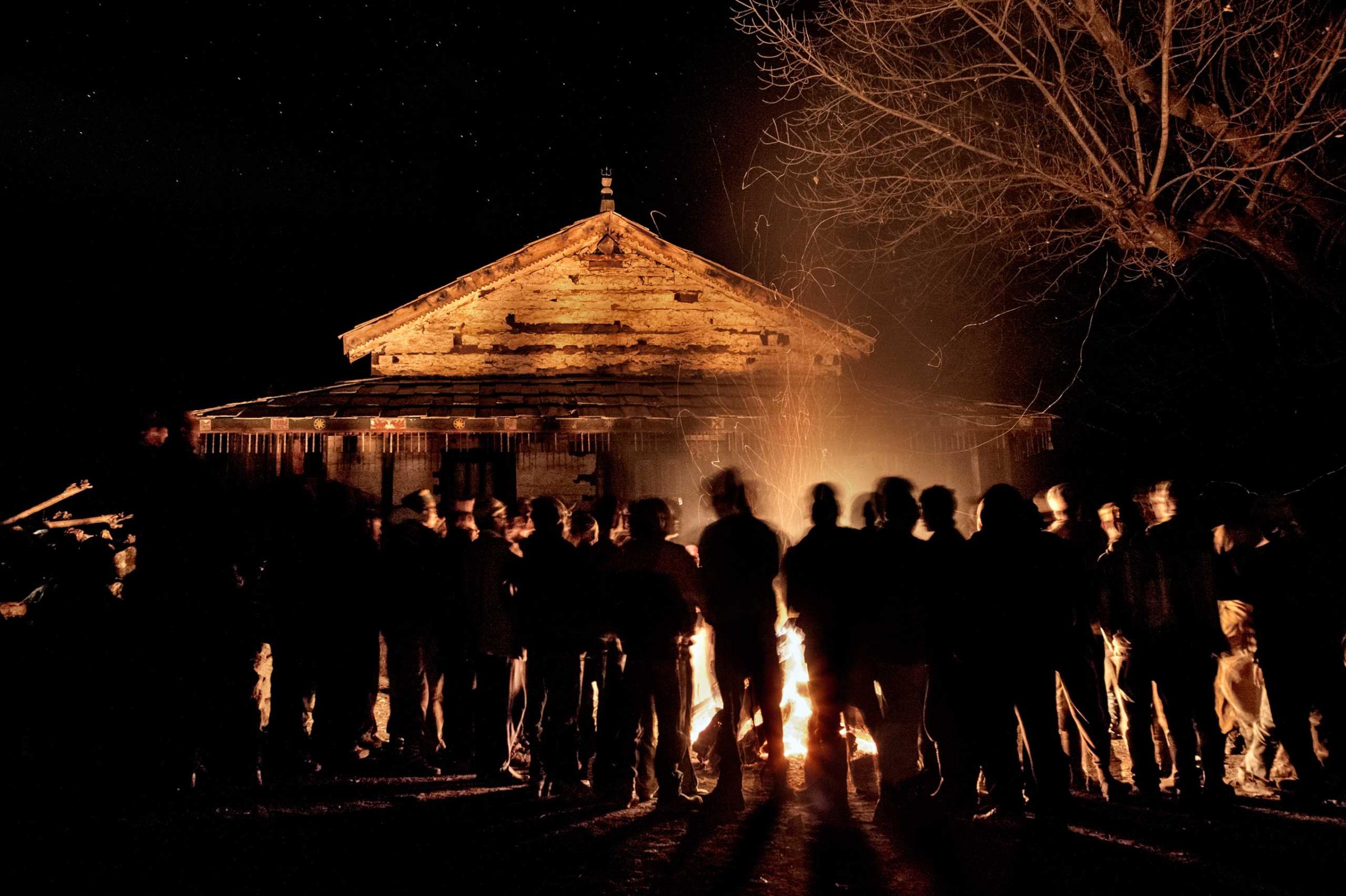 Villagers gather around a big fire set in front of the temple in occasion of the mela. Villagers are mainly Hindu, although they hail as well minor deities worshipped in the mountains, locally known as devta