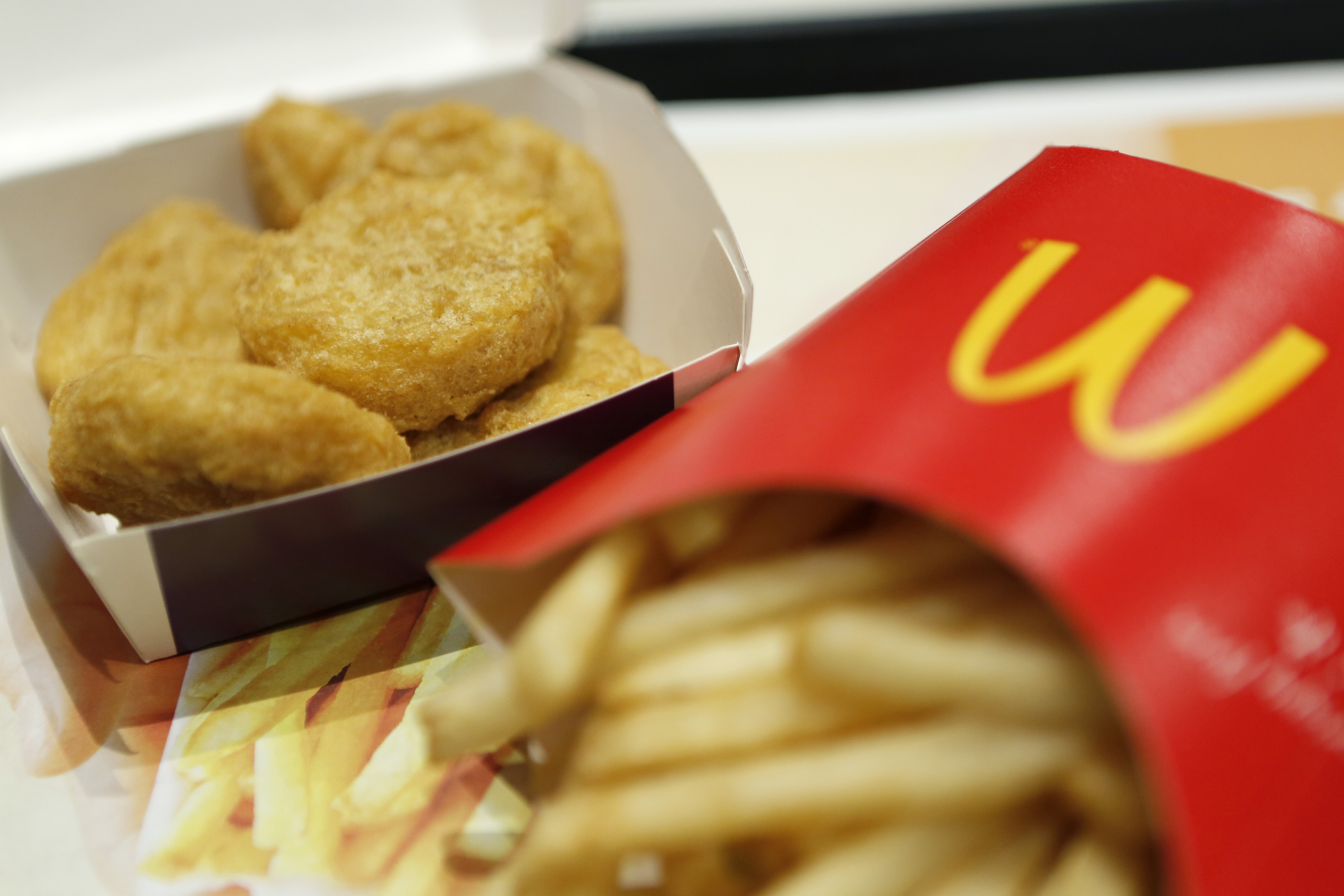 A box of chicken nuggets, left, sits beside a portion of french fries at a McDonald's restaurant, operated by McDonald's Holdings Co. Japan Ltd., in Tokyo, Japan, on Jan.7, 2015. (Bloomberg—Getty Images)