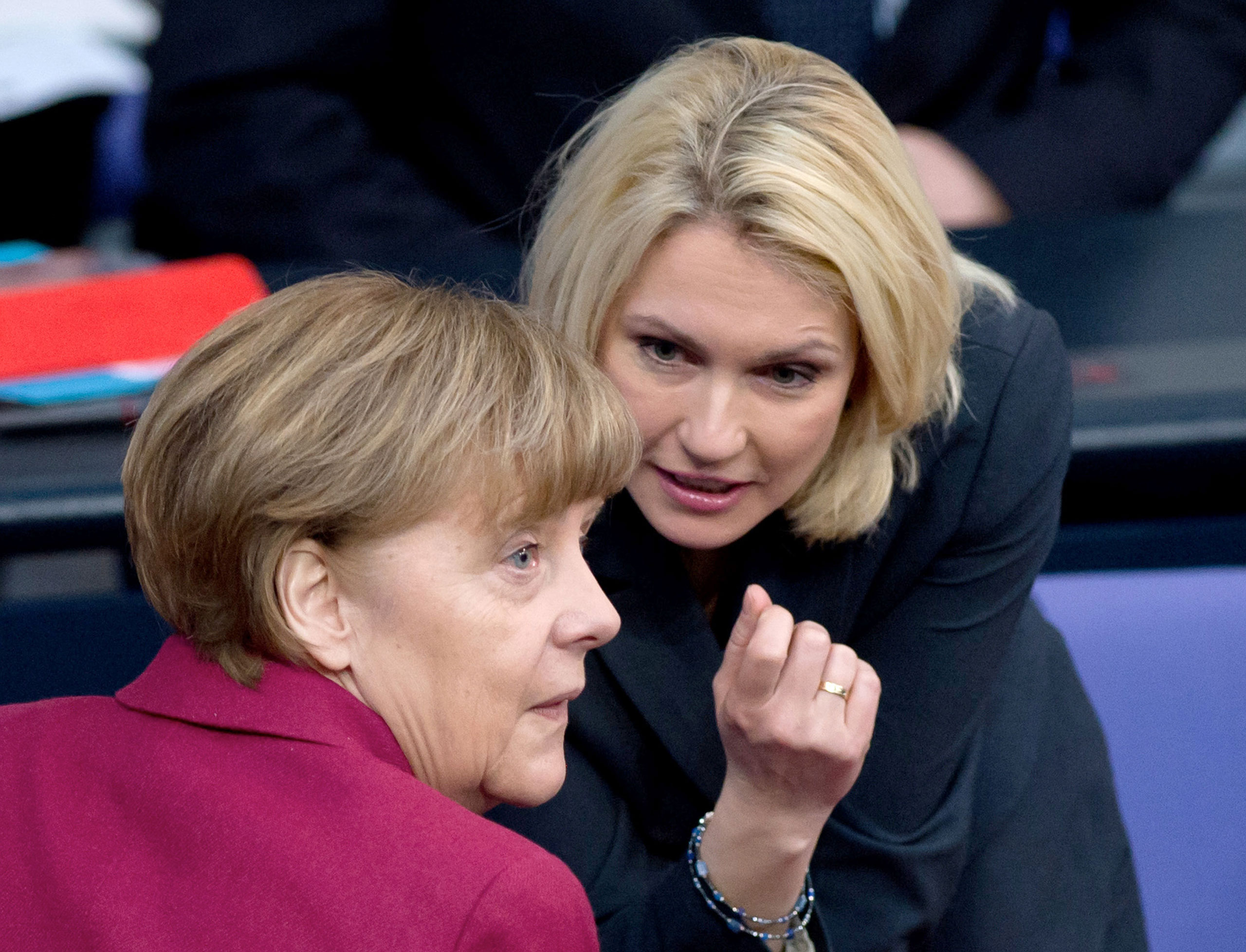 German chancellor Angela Merkel, left, and German Minister of Family Affairs Manuela Schwesig talk during a session of parliament in Berlin, March 6, 2015. (Soeren Stache—EPA)