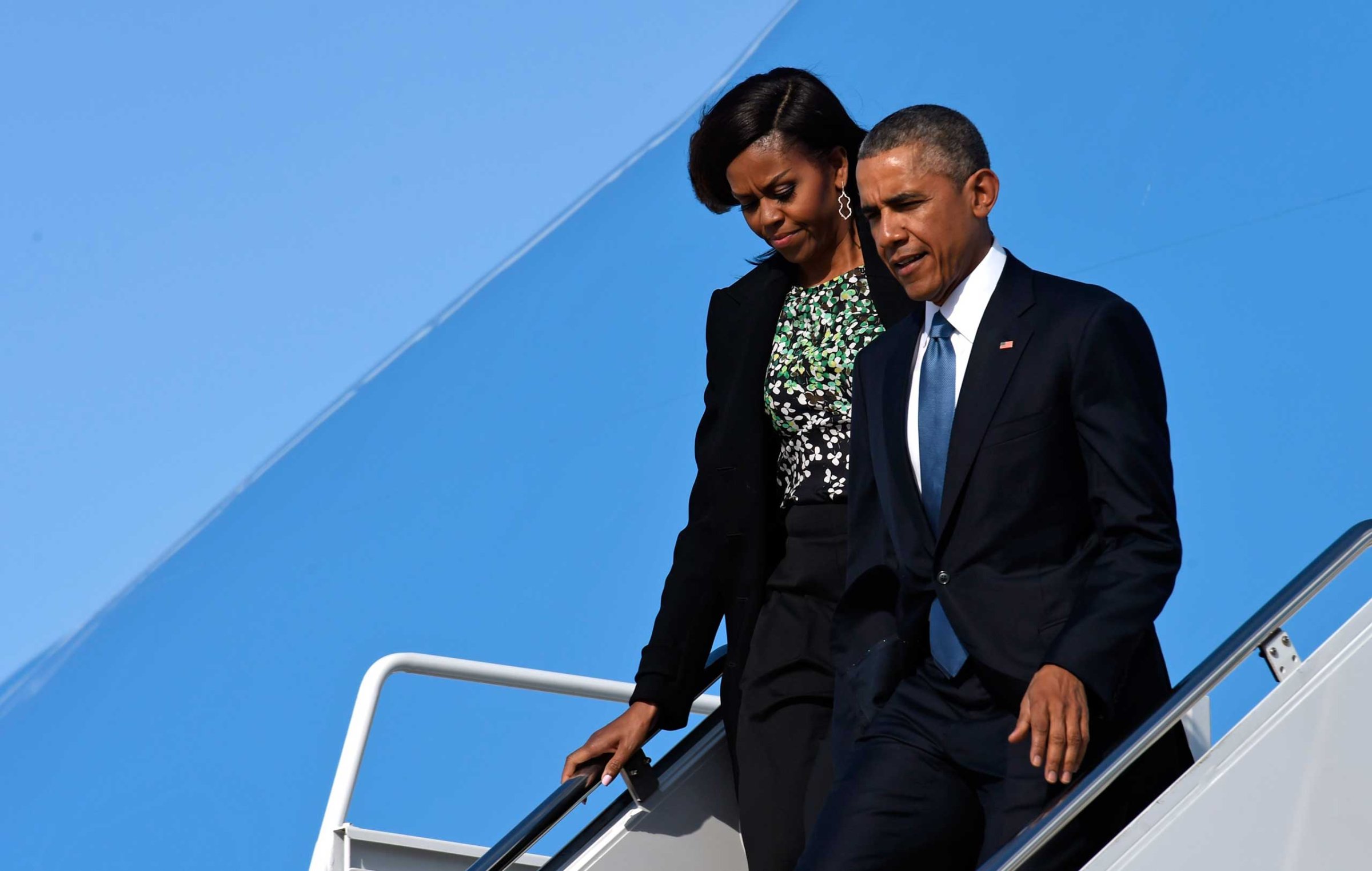 President Barack Obama and first lady Michelle Obama walk down the steps of Air Force One at Andrews Air Force Base in Md., Monday, March 30, 2015.