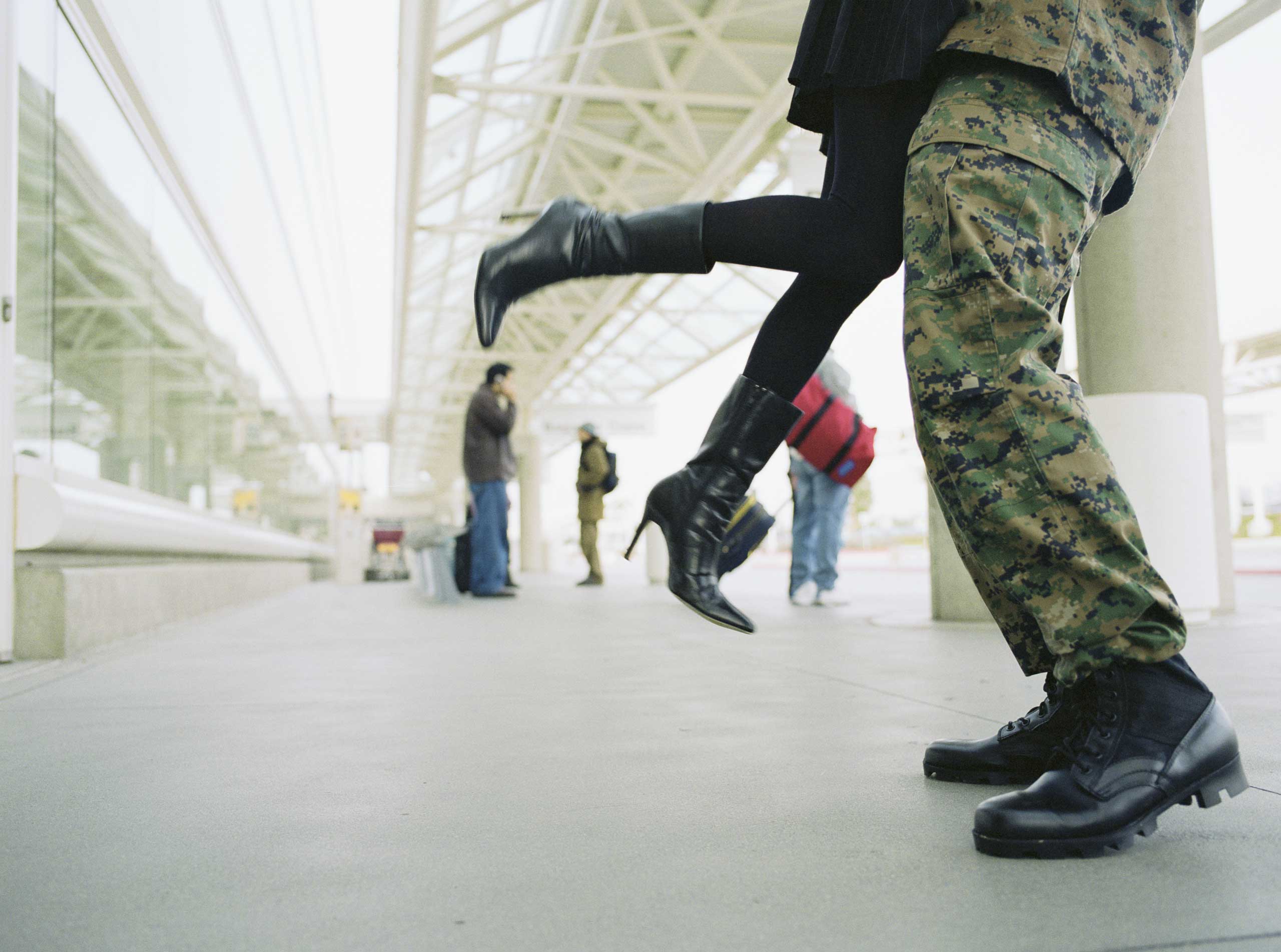 A stock image of a man in a military uniform lifting up a woman