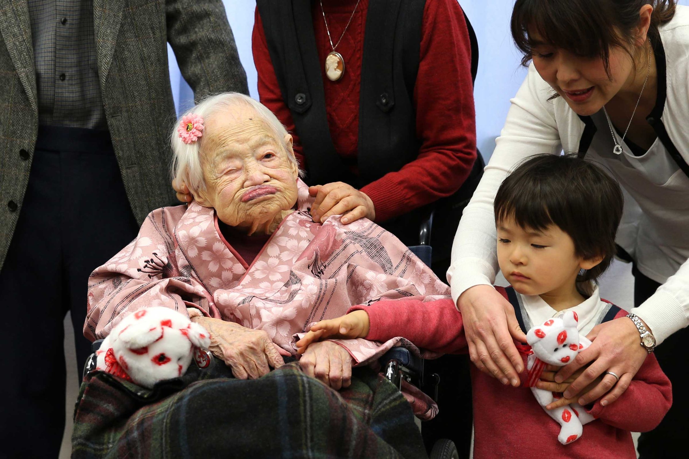 Misao Okawa, the world's oldest Japanese woman poses for a photo with her great-grandchild Himaki and grandchild Takako Okawa on her 117th birthday celebration at Kurenai Nursing Home on March 4, 2015 in Osaka, Japan.