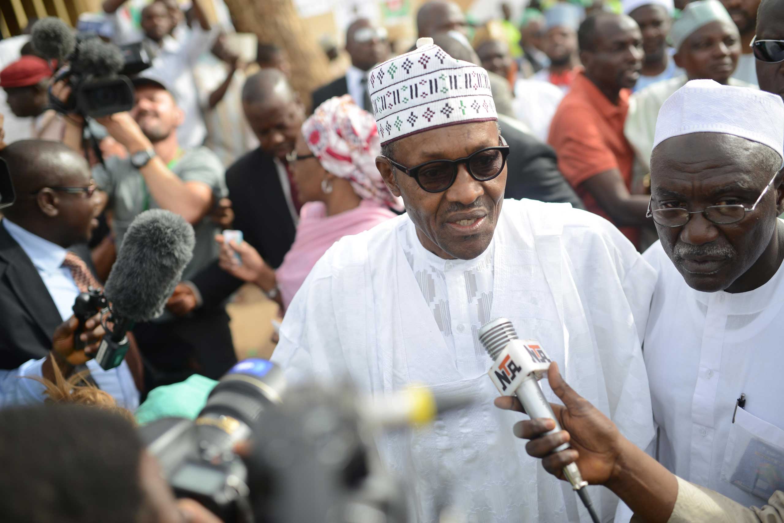 Mohammadu Buhari, the presidential candidate of the main opposition party All Progressives Congress, speaks to the press as he arrives for registration at Gidan Niyam Sakin Yara polling station in Daura district of Katsina, Nigeria, on March 28, 2015 (Anadolu Agency—Getty Images)