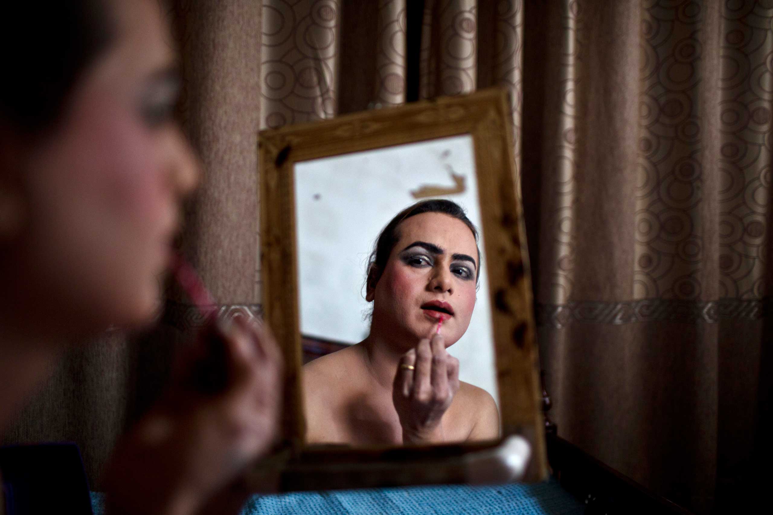 The Washington Post In Sight:  Leading a Double Life in PakistanWaseem Akram, 27, applies makeup on his face as he prepares himself for a party at a friend's place in Rawalpindi, Pakistan, Jan. 10, 2015.