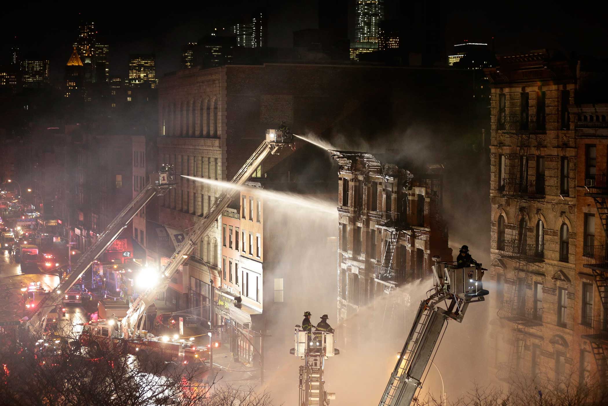 Firefighters respond to an explosion and partial building collapse in a residential and commercial mixed use multi-story structure in lower Manhattan, New York on March 26, 2015.