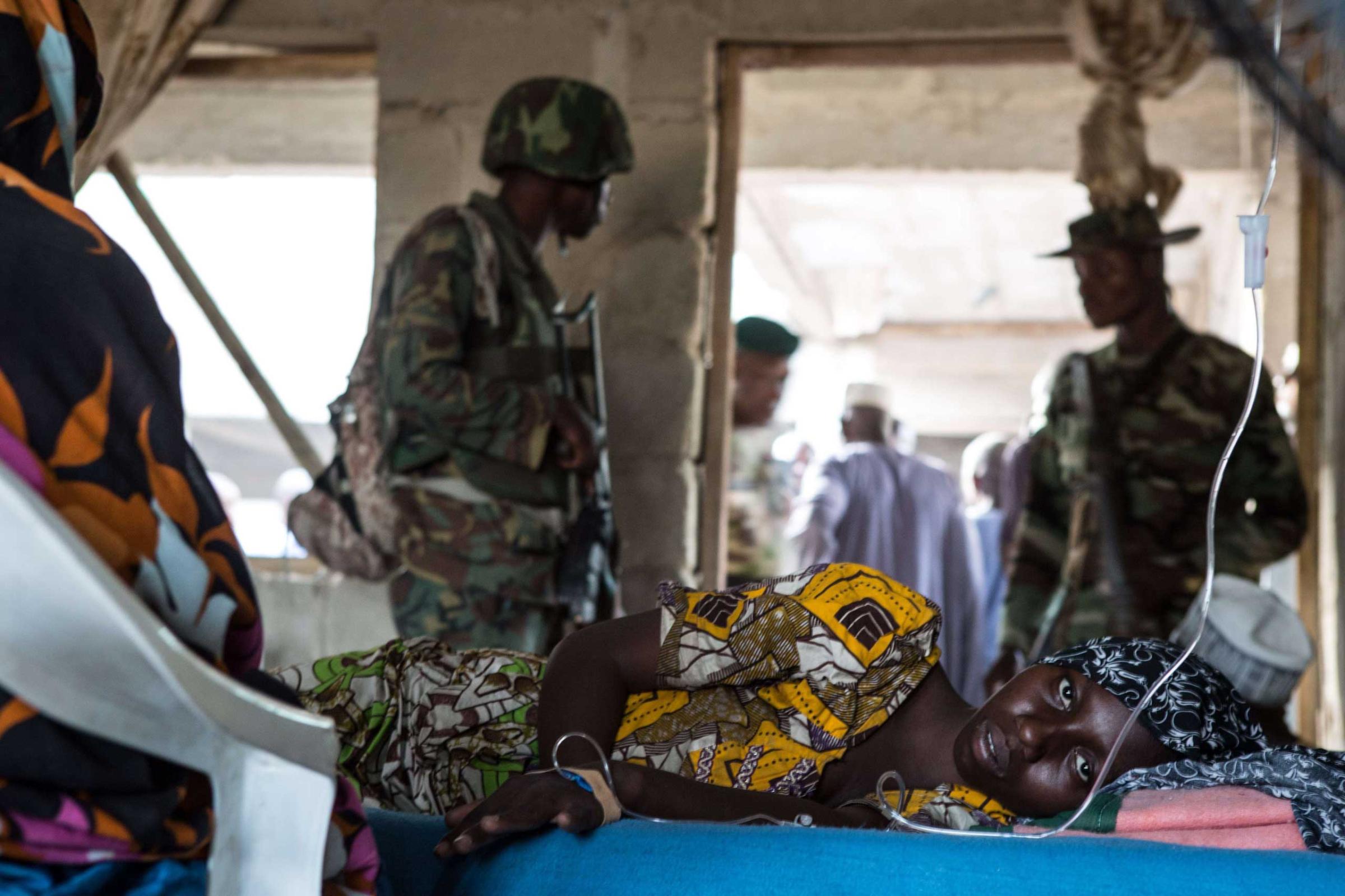 A young woman lies ill in a makeshift hospital room in Maiduguri on March 25, 2015.