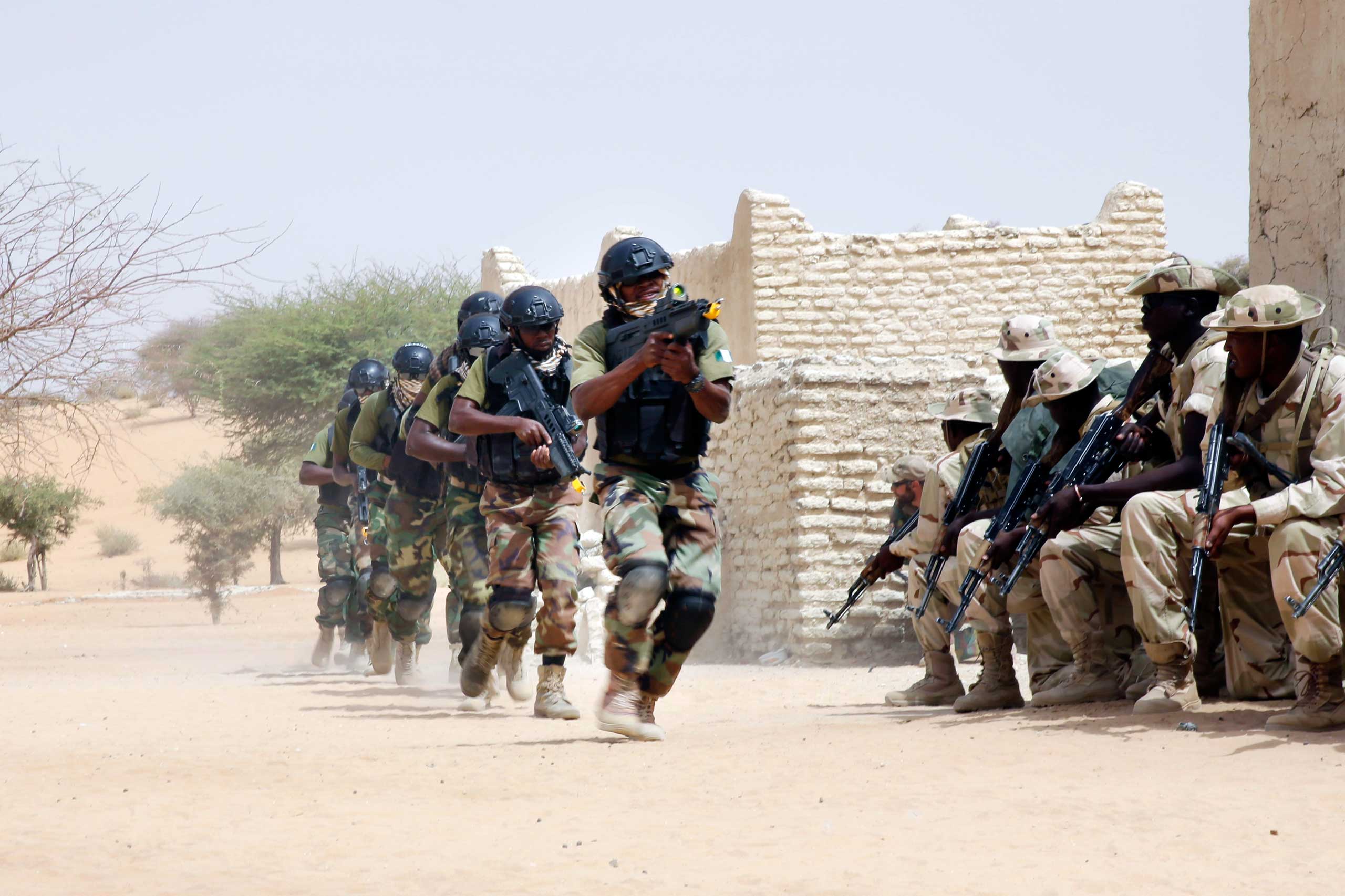 Nigerian special forces run past Chadian troops in a hostage rescue exercise at the end of the Flintlock exercise in Mao, Chad on March 7, 2015. (Jerome Delay—AP)