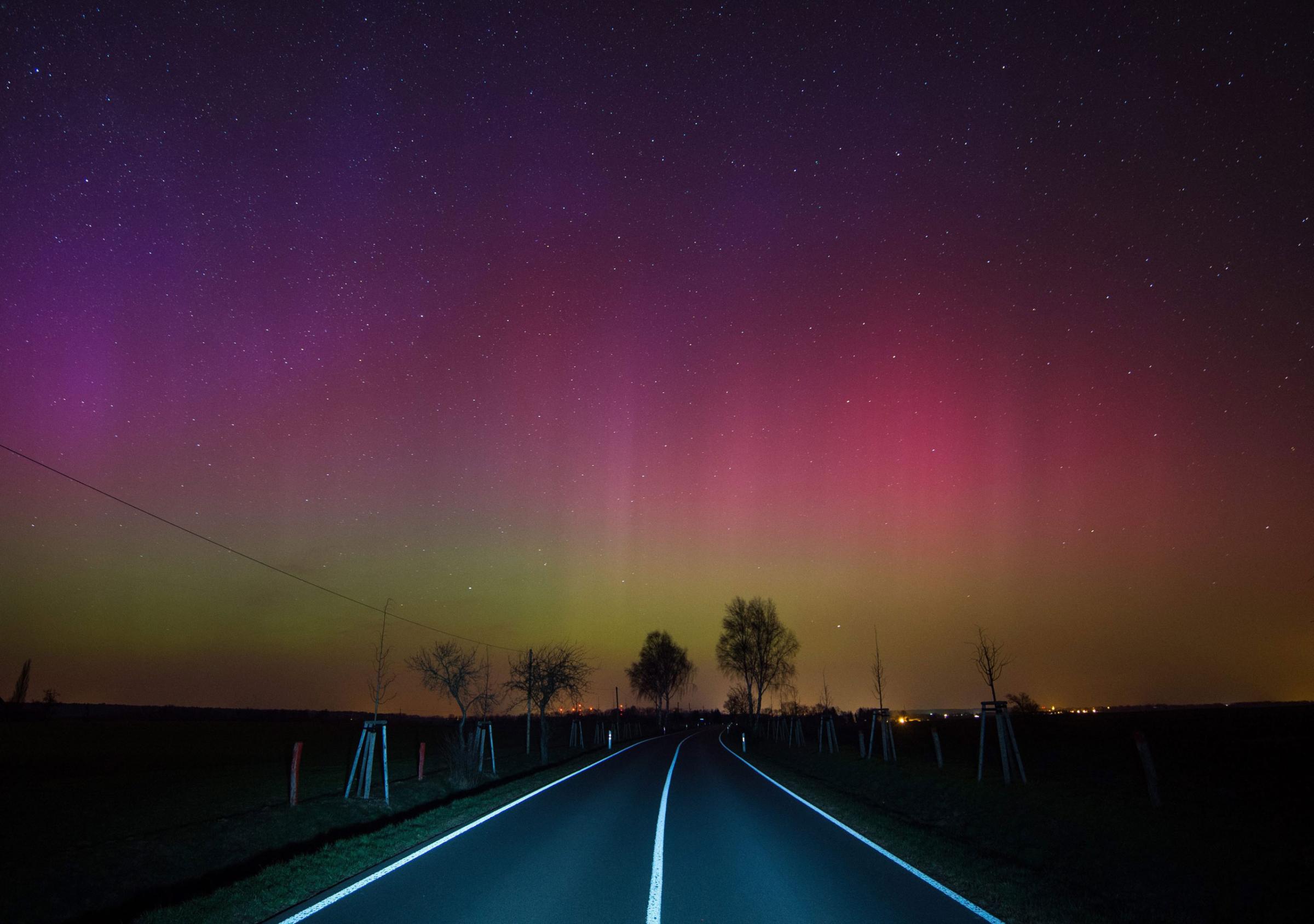 The Northern Lights over a country road near Lietzen in Maerkisch-Oderland, Germany, on March 17, 2015.