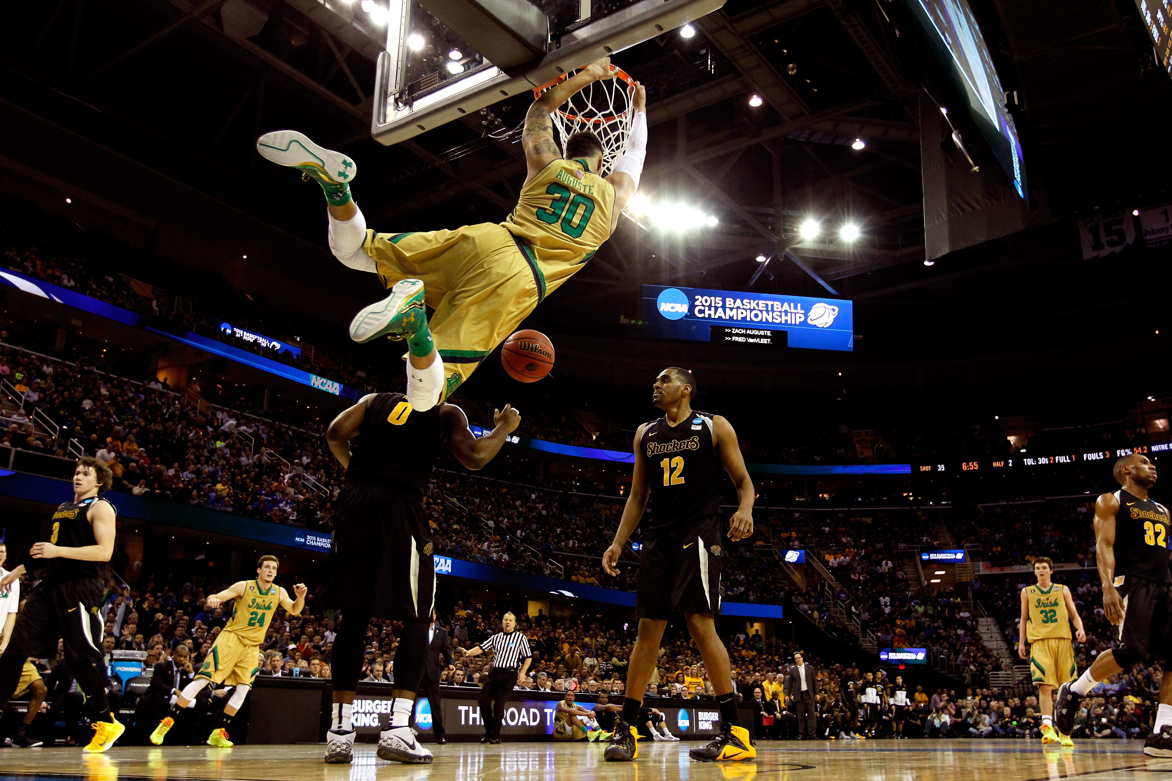 Zach Auguste #30 of the Notre Dame Fighting Irish dunks in the second half against Rashard Kelly #0 and Darius Carter #12 of the Wichita State Shockers during the Midwest Regional semifinal of the 2015 NCAA Men's Basketball Tournament at Quicken Loans Arena on March 26, 2015 in Cleveland, Ohio.