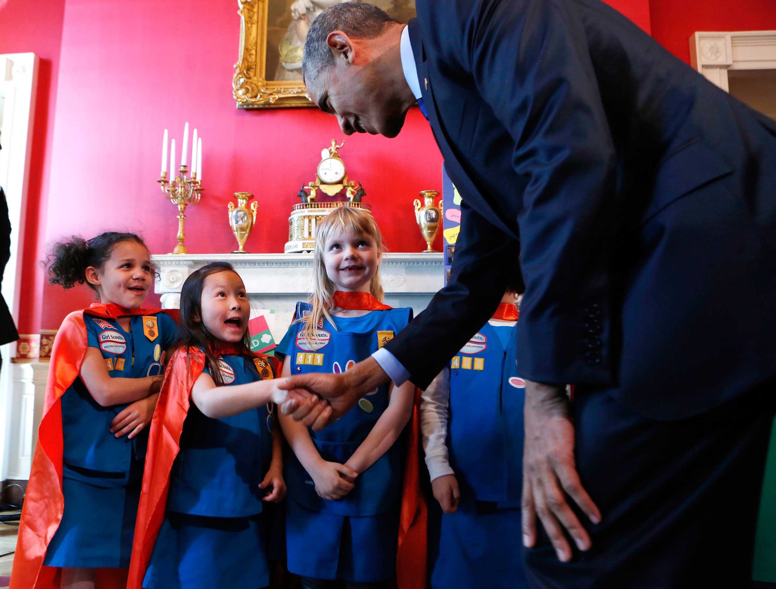 U.S. President Barack Obama (R) shakes hands with a group of  six-year-old Girls Scouts from Tulsa Oklahoma who designed a battery powered page turner to help people who are paralyzed or have arthritis at the 2015 White House Science Fair in Washington on March 23, 2015. (Aude Guerrucci—Pool/Getty Images)