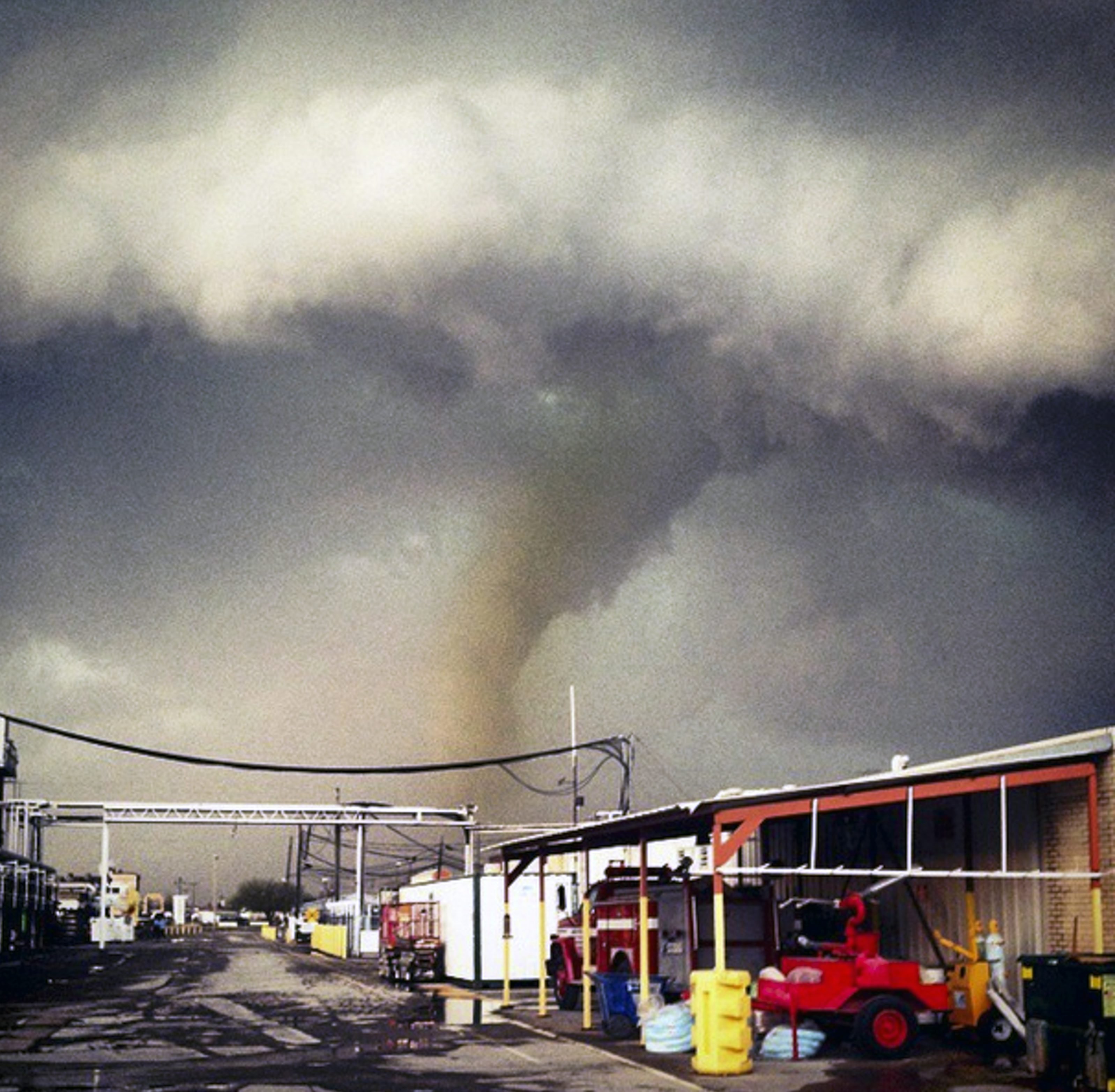 The funnel cloud of a tornado reaches down to the ground as a storm approaches Sand Springs, Okla. on March 25, 2015.