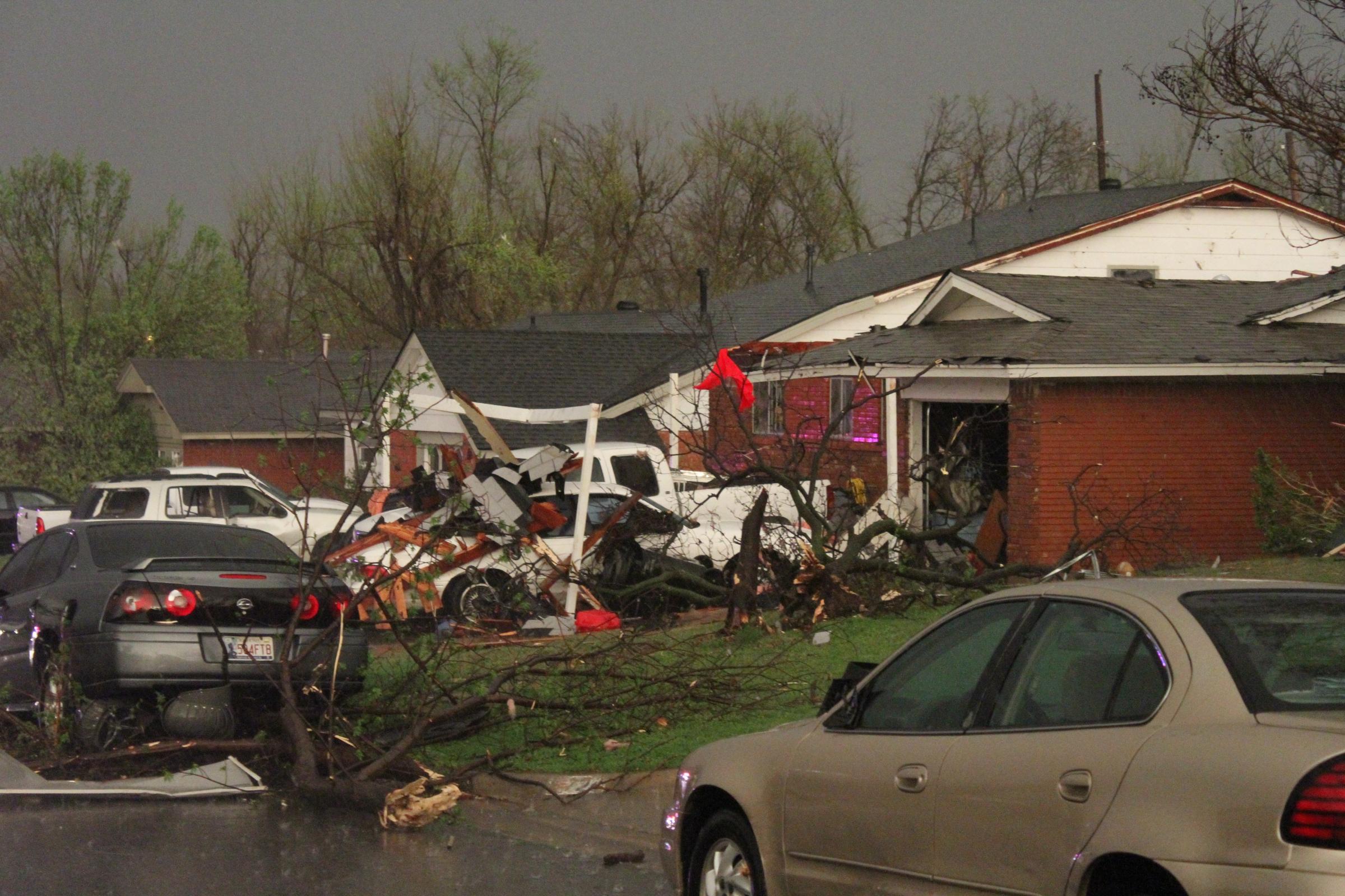Cars, homes, downed trees and buildings damaged by a storm that spawned a tornado in Moore, Okla. on March 25, 2015.