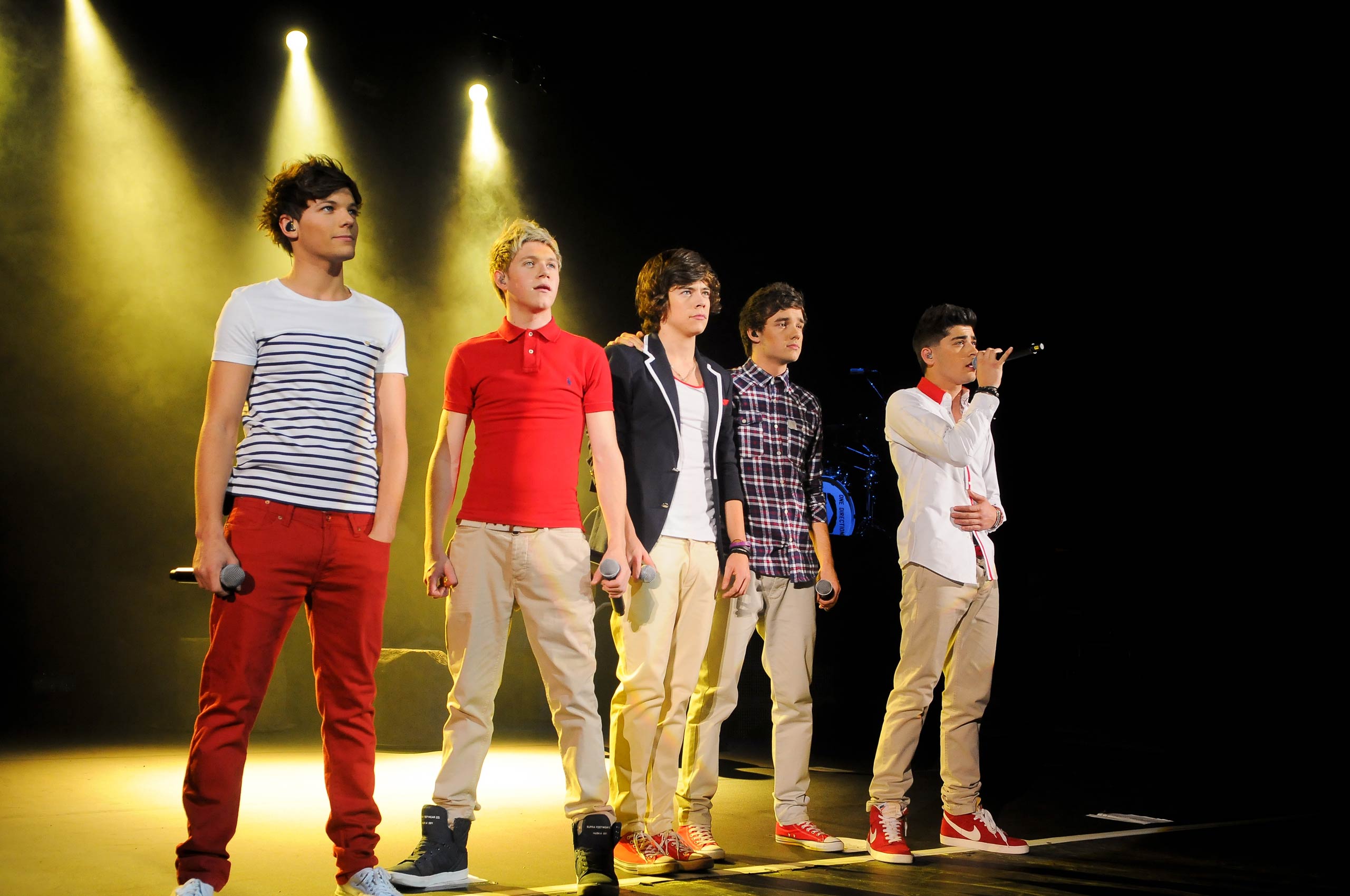 Louis Tomlinson, Niall Horan, Harry Styles, Liam Payne and Zayn Malik of One Direction perform at HMV Hammersmith Apollo in London, England in 2012.