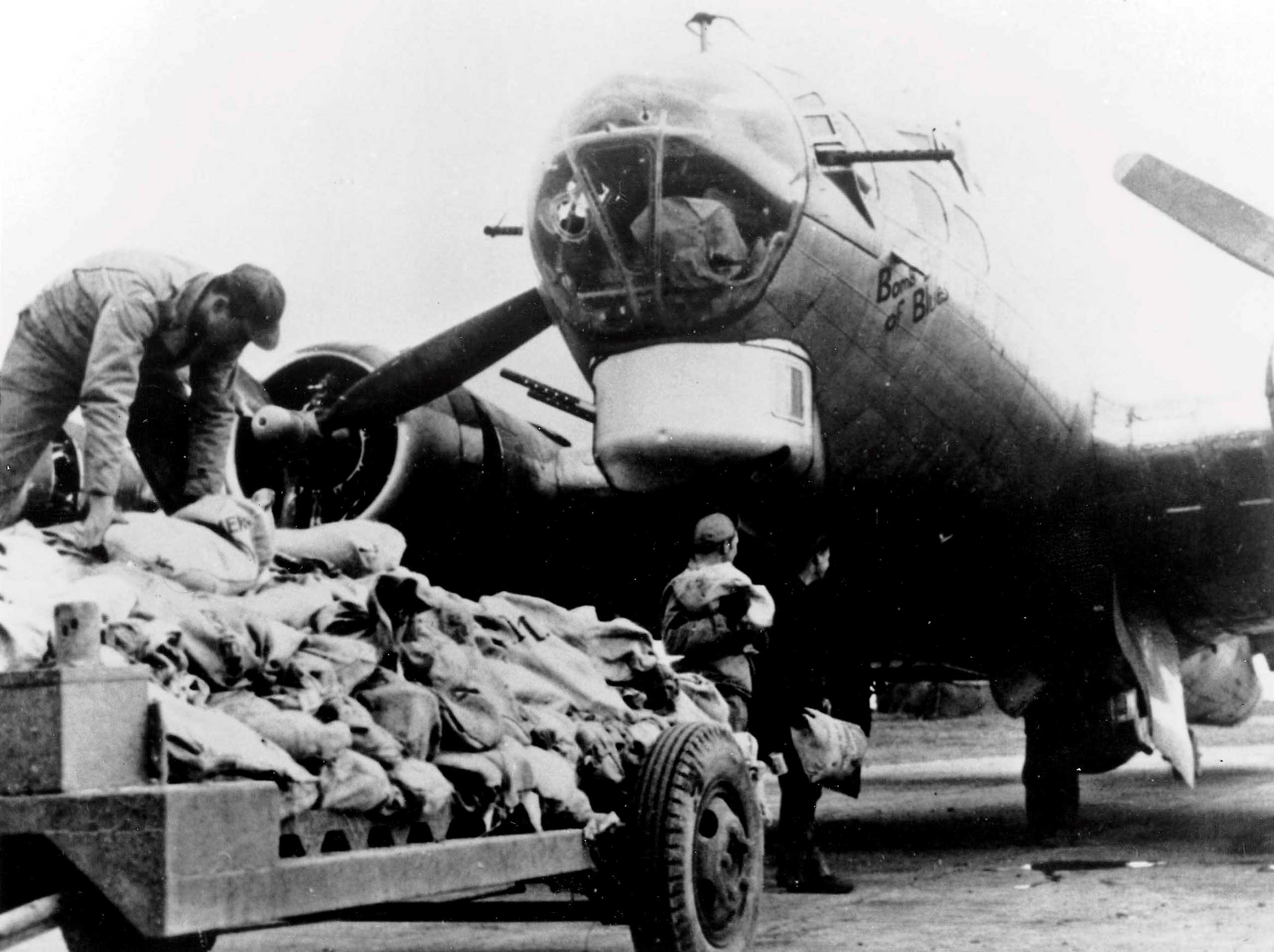 Workers load food onto an American B17 bomber during Operation Chowhound which involved dropping essential food supplies from bombers to the starving Dutch people at the end of WWII.