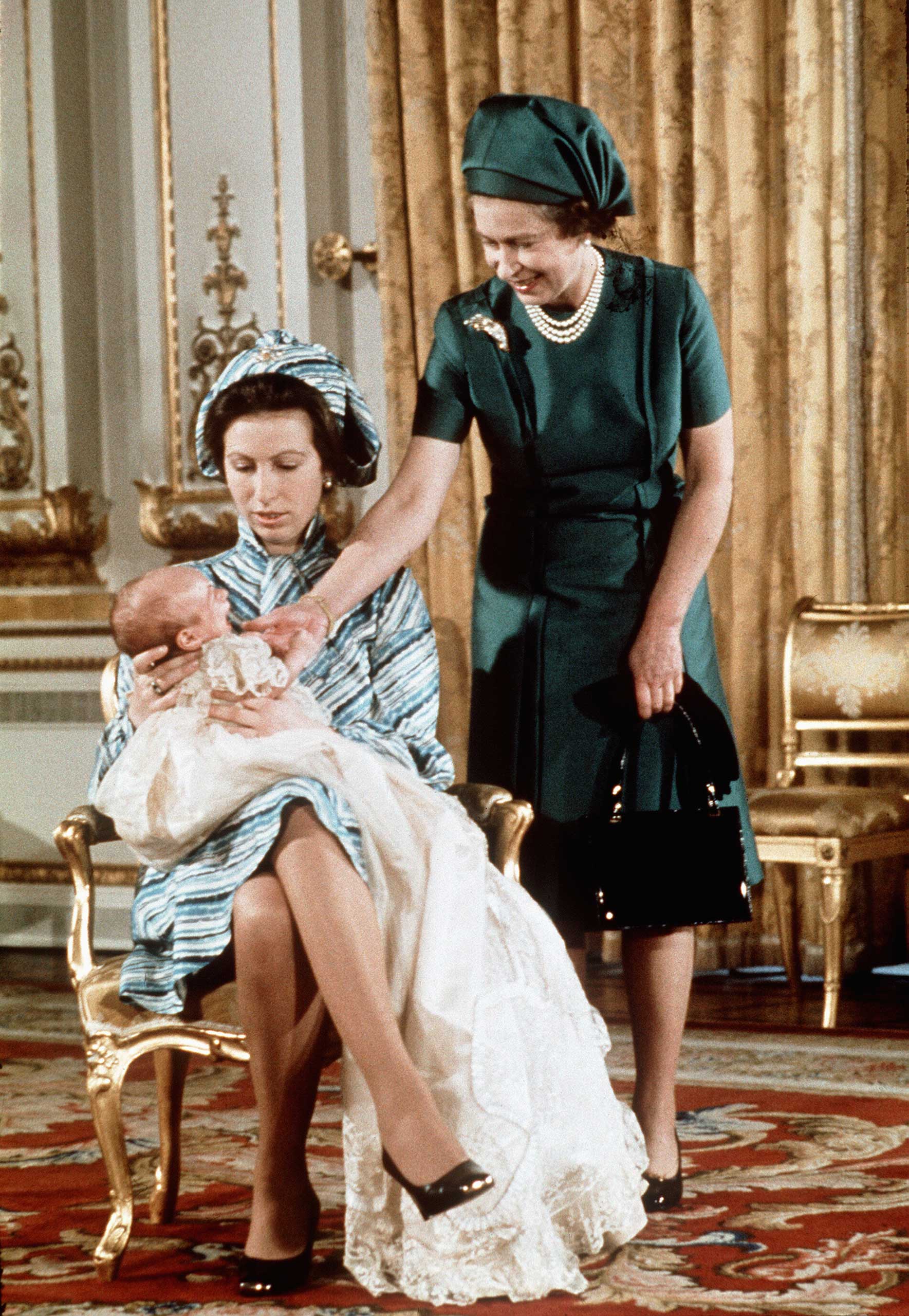 The Queen admires her first grandchild, Peter Phillips, at Balmoral Castle in November 1977.  Peter's mother, Princess Anne, declined royal titles for both of her children.
