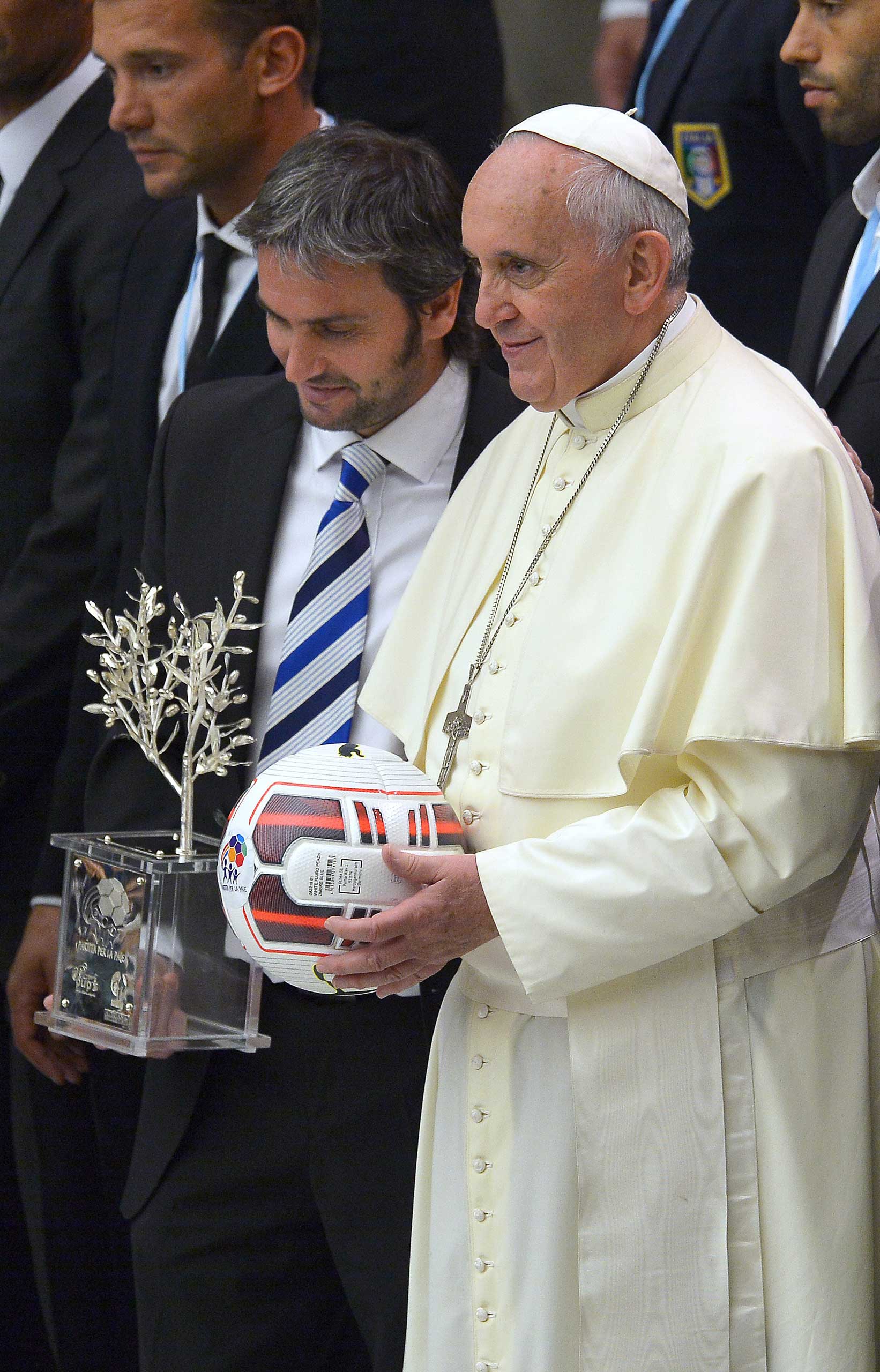 Pope Francis stands next to Argentinian craftsman Adrian Pallarols as he poses for the family photo with international football players at the Vatican on Sept. 2014 prior to an inter-religious "match for peace" soccer game that played at Rome's Olympic Stadium.