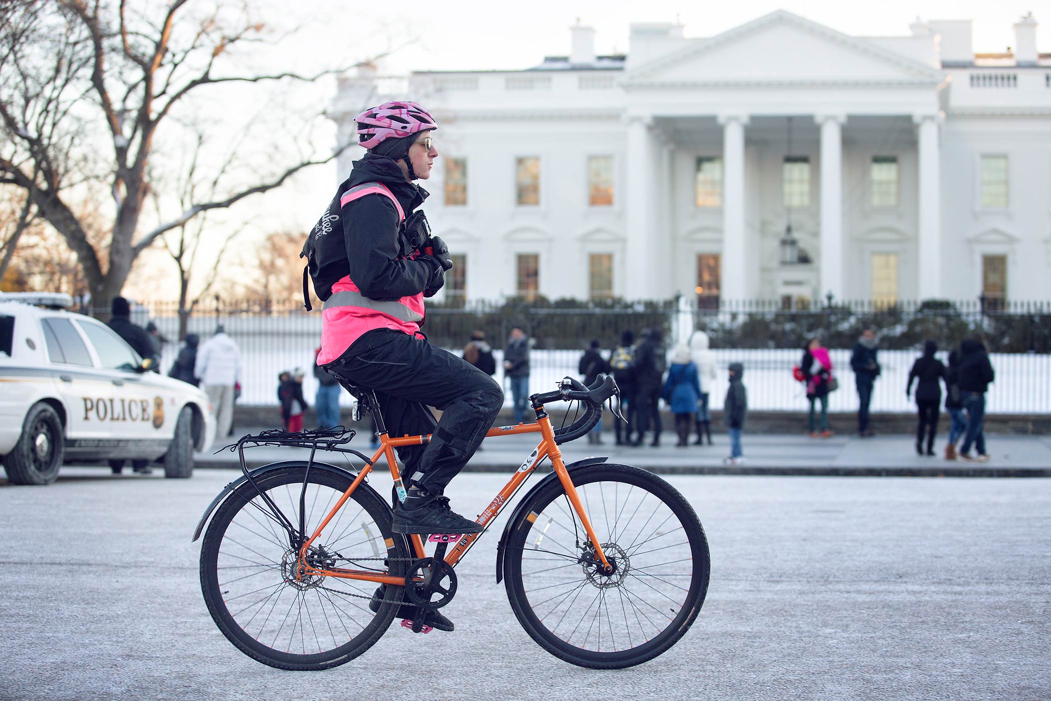 Postmates bike messenger Alex Caron-Schuler rides on Pennsylvania Avenue NW in front of the White House on Jan. 3, 2014. (Willis Bretz—The Washington Post/Getty Images)