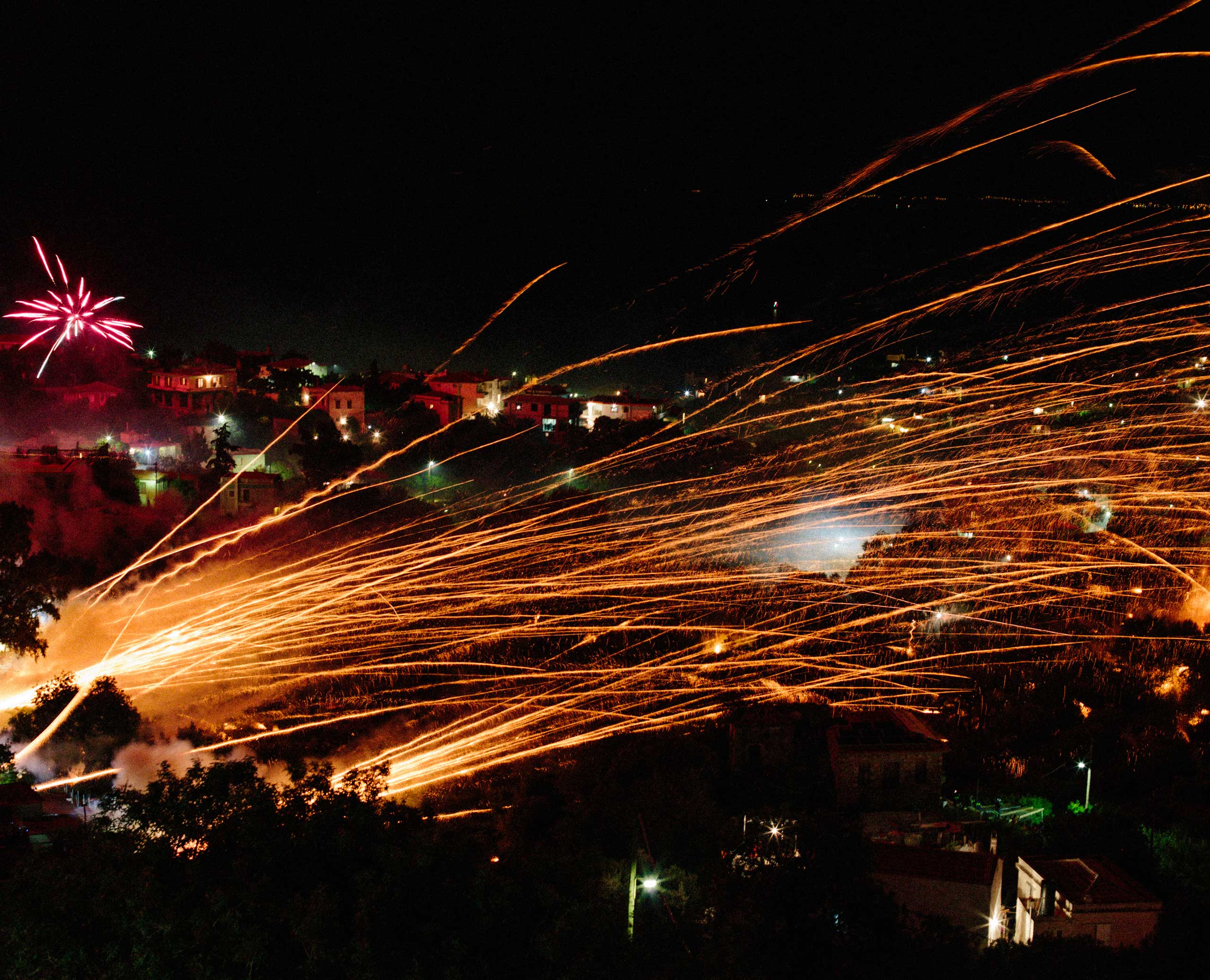 Agios Markos fire their rockets across the valley, towards the church of Panageia Erithiani in Vrontados, Chios, Greece.