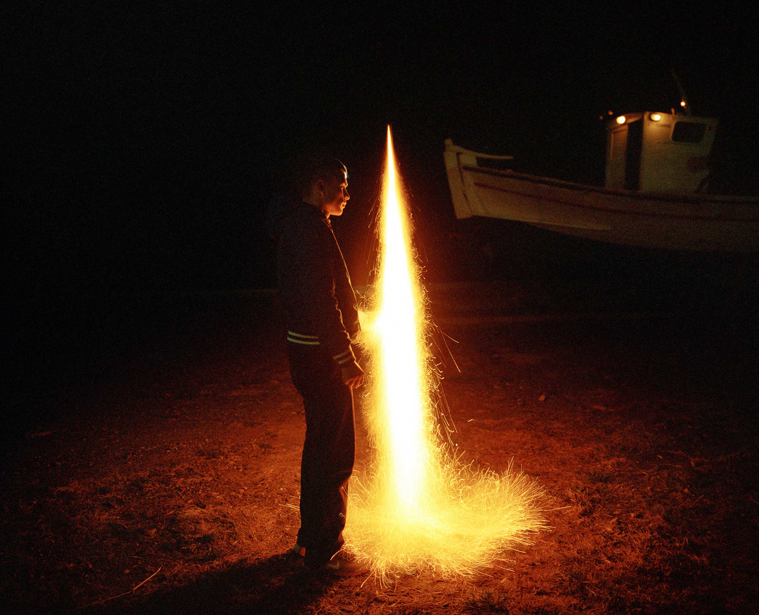 A rocket is lit at a small fishing port in Vrontados.
