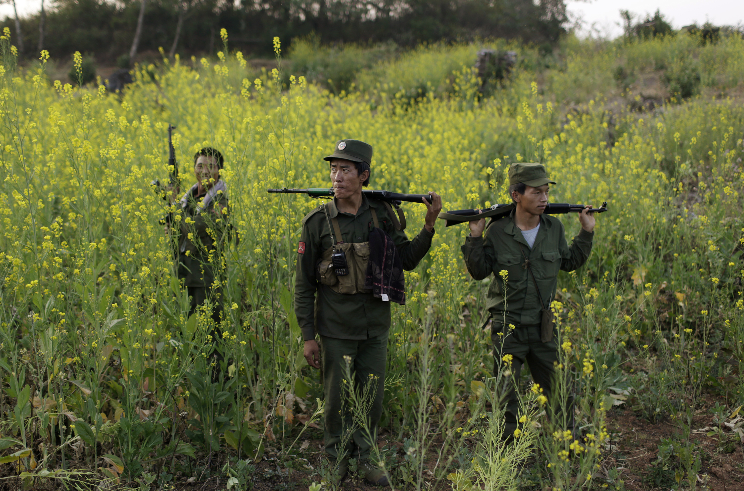 Rebel soldiers of Myanmar National Democratic Alliance Army patrol near a military base in Kokang region, in Burma, on March 10, 2015 (Reuters)