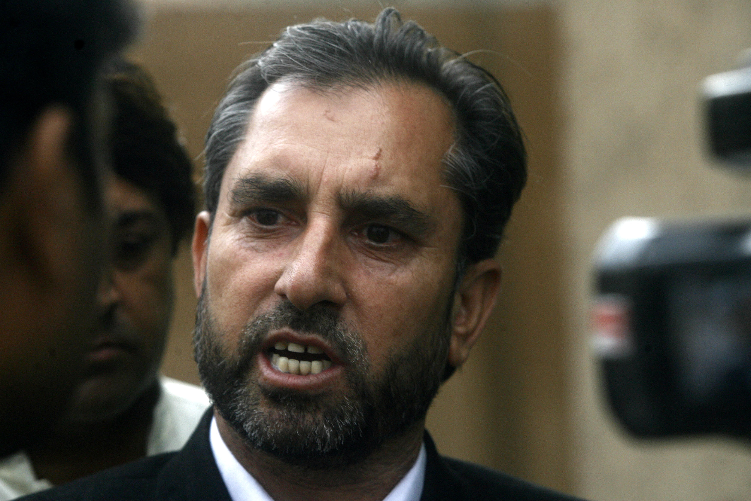 Afridi, lawyer for a Pakistani doctor who helped U.S. officials find al-Qaeda chief Osama bin laden, speaks to the media in Peshawar