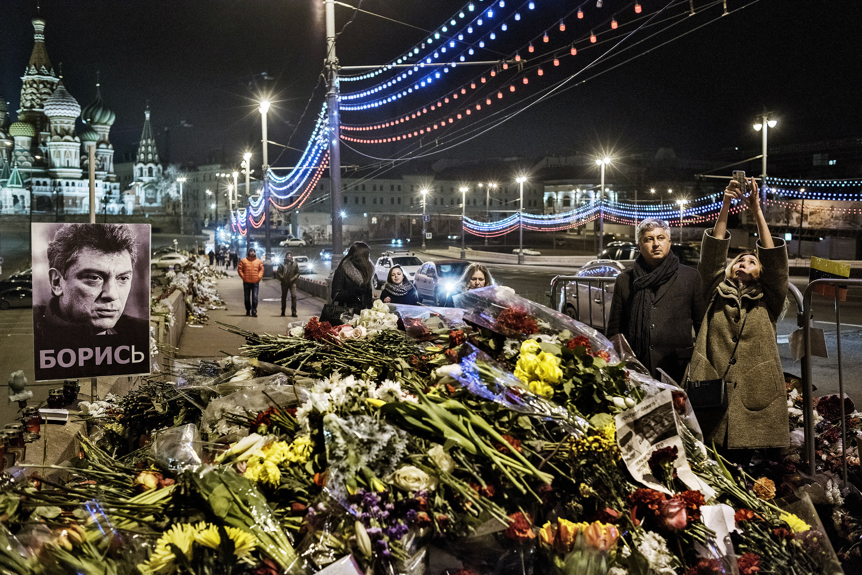 Passersby stop at the spot where opposition leader Boris Nemtsov was murdered. (Yuri Kozyrev—NOOR for TIME)