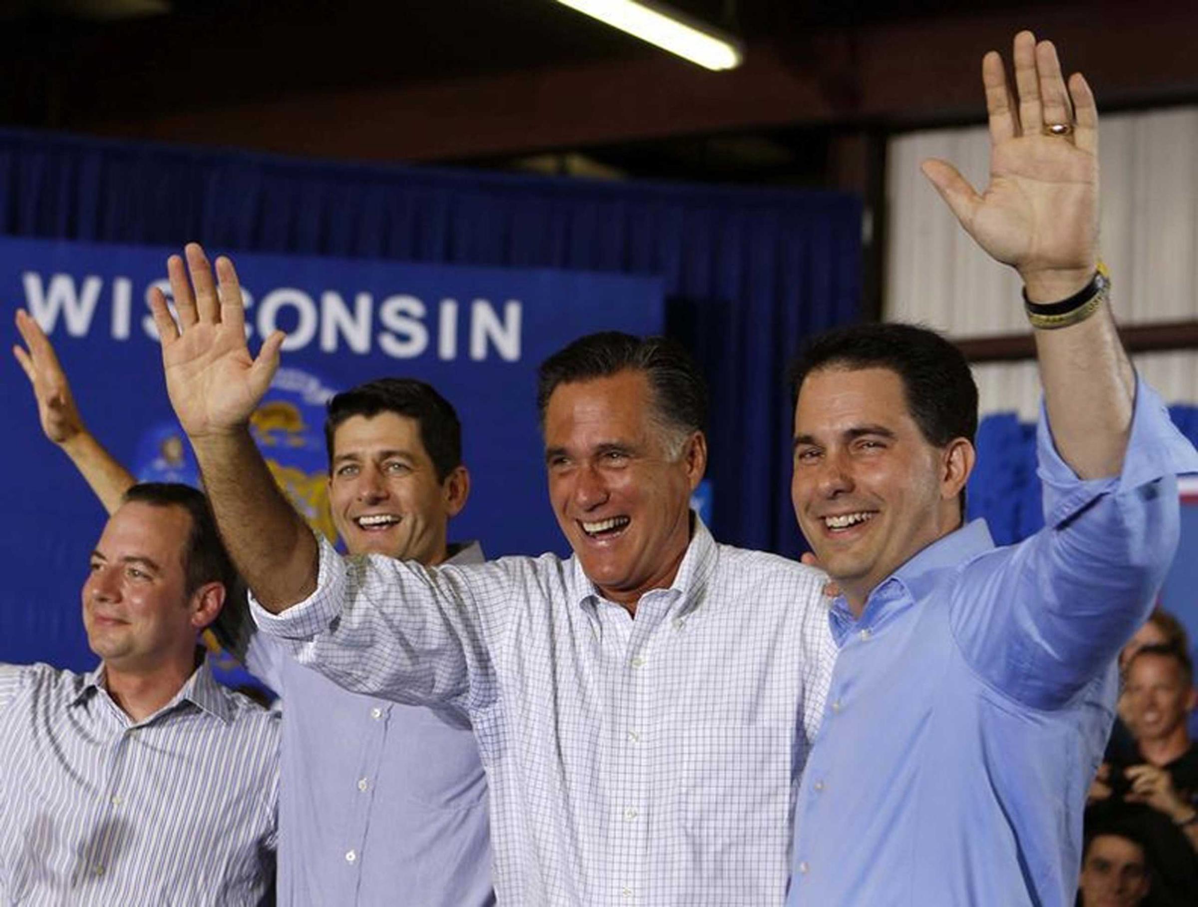 U.S. Republican Presidential candidate Mitt Romney (2nd R) waves next to Governor Scott Walker (R), Representative Paul Ryan (2nd L), and RNC Chairman Reince Priebus (L) before speaking to a crowd at Monterey Mills in Janesville, Wis., June 18, 2012.
