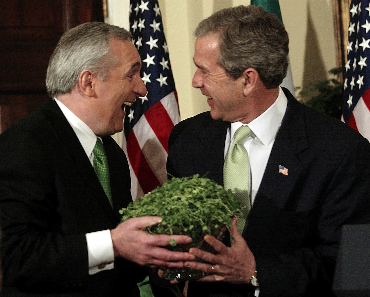WASHINGTON, :  US President George W. Bush receives a bowl of shamrocks from Irish Prime Minister Bertie Ahern (L) on March 13, 2002. (Stephen Jaffe—AFP/Getty Images)