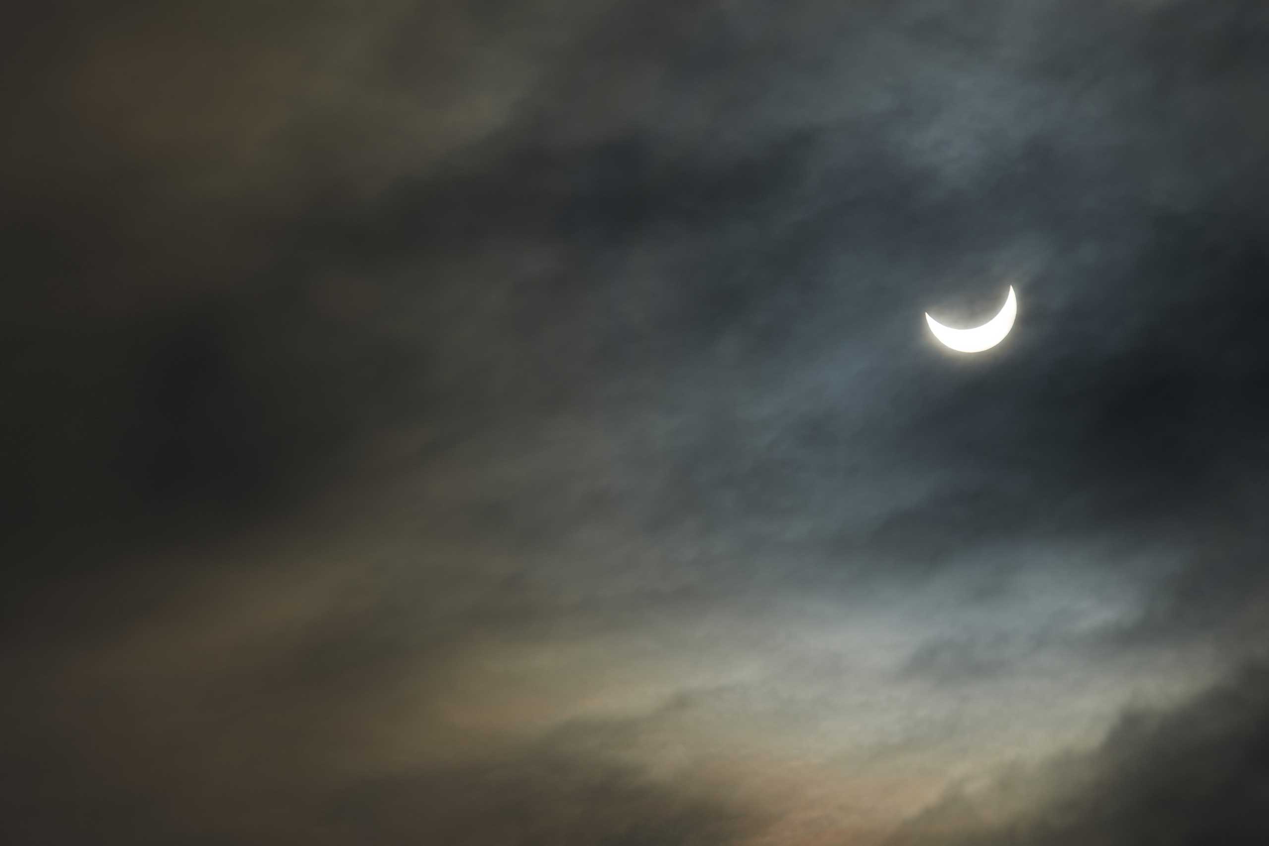 The sun through clouds during the maximun solar eclipse seen from the Jolimont observatory in Toulouse, France on March 20, 2015.