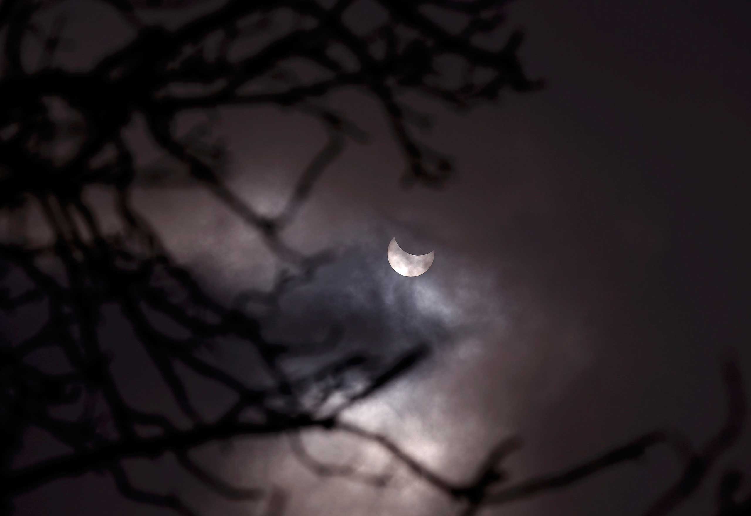 A partial solar eclipse is seen through clouds in Sofia, Bugaria on March 20, 2015.